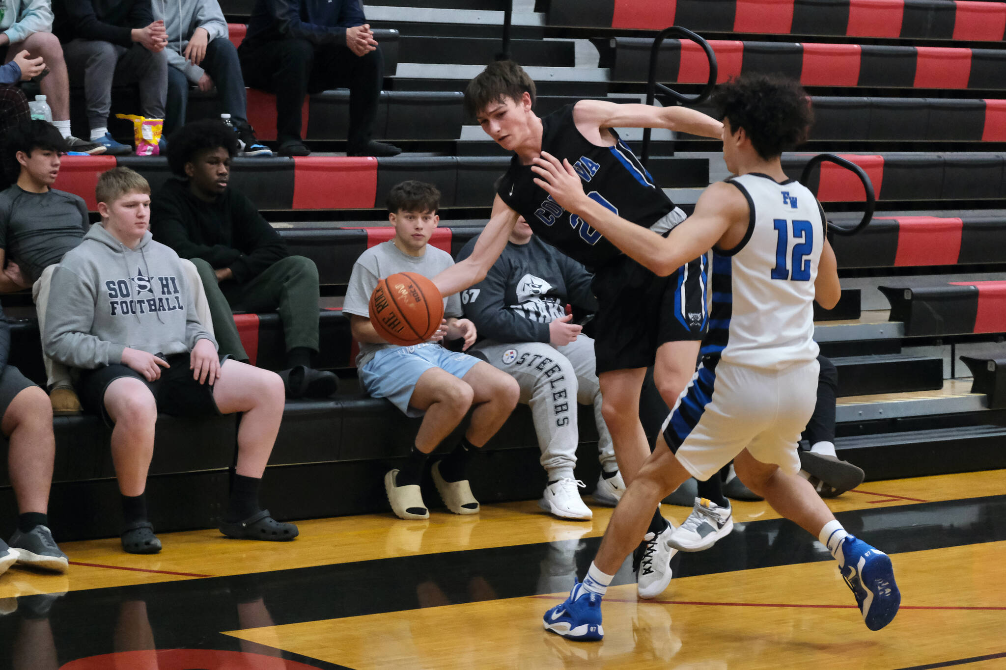 Cordova senior Thomas Nothstine (20) saves a ball against Federal Way sophomore Julian Barrett in the Wolverines 64-31 loss to the Eagles during Saturday action at the George Houston Capital City Classic in Juneau. (Klas Stolpe / Juneau Empire)