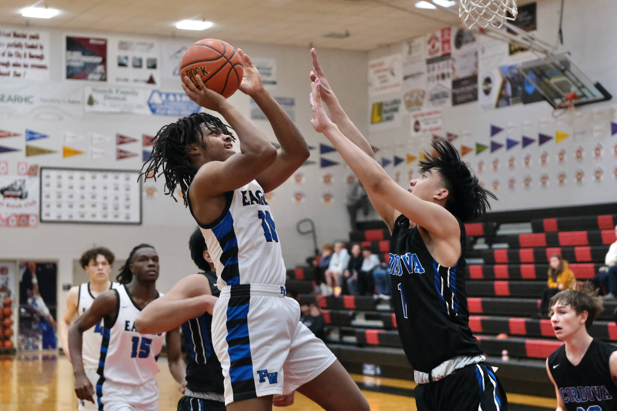 Federal Way senior Jacob Hurskin (10) scores over Cordova senior John Itliong (1) in the Eagles 64-31 win over the Wolverines during Saturday action at the George Houston Capital City Classic in Juneau. (Klas Stolpe / Juneau Empire)