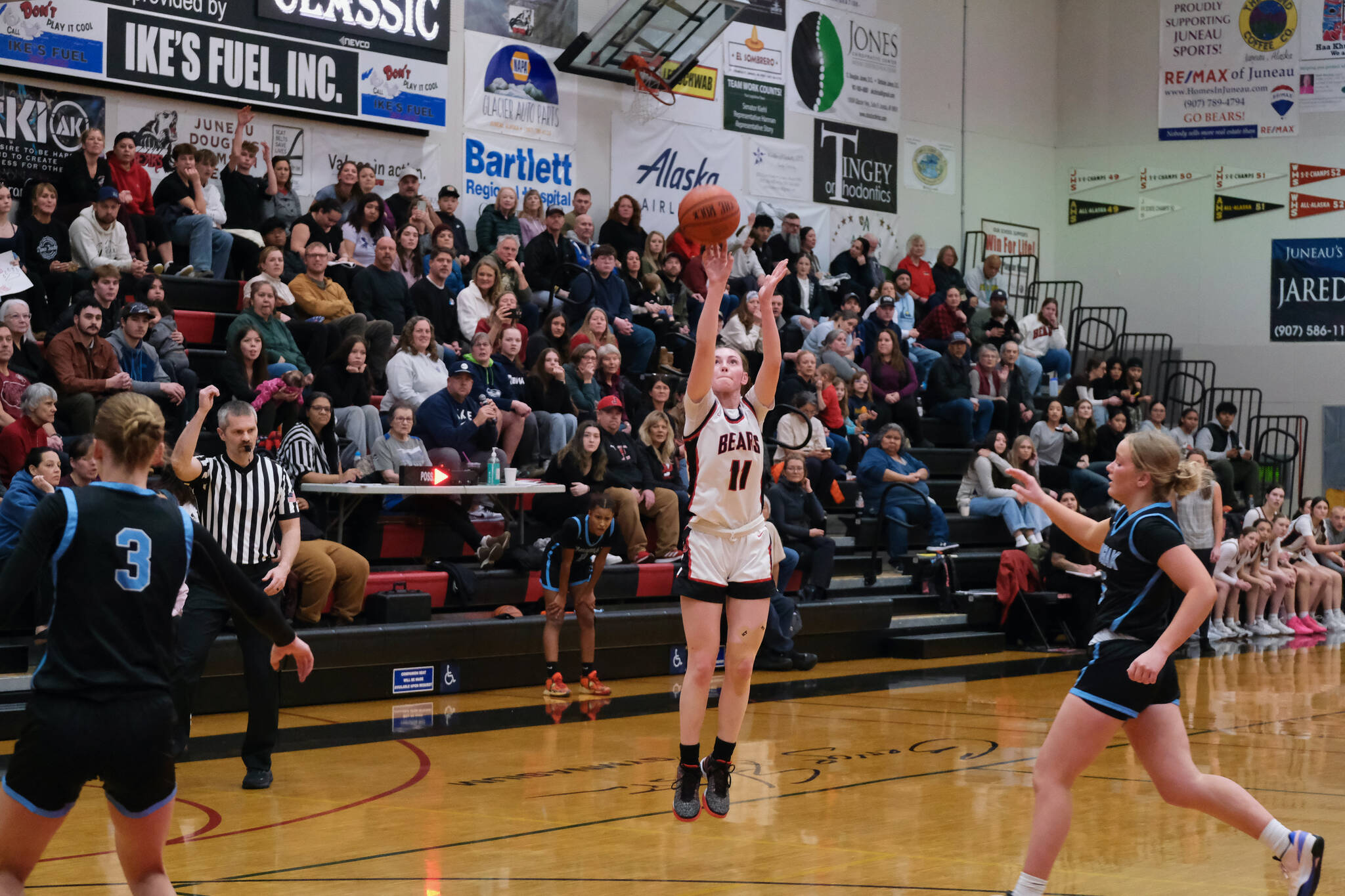 Juneau-Douglas High School: Yadaa.at Kalé junior Gwen Nizich (11) shoots from past the arch against Chugiak during the Crimson Bears 51-38 win over the Mustangs in the girls championship game at the George Houston Capital City Classic on Sunday in Juneau. (Klas Stolpe / Juneau Empire)