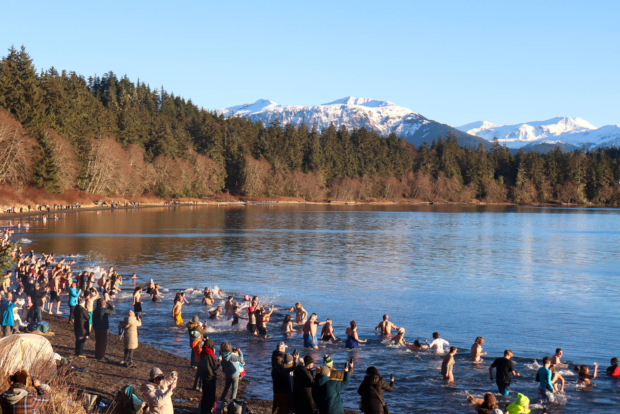 Hundreds of people plunge into Auke Rec on New Year’s Day in Juneau. (Jasz Garrett / Juneau Empire)