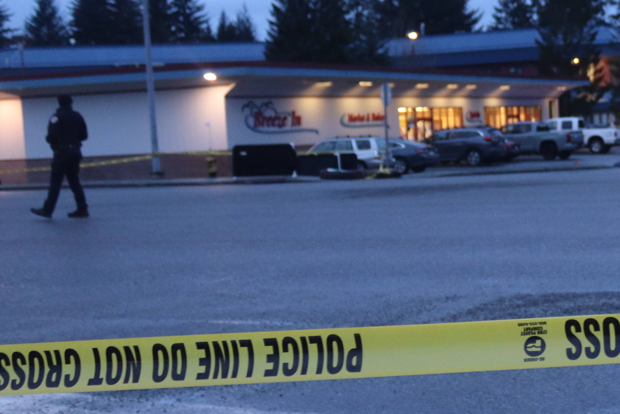 A Juneau Police Department officer monitors the perimeter of a marked-off area next to the Mendenhall Valley Breeze In after a women carrying a hatchet was fatally shot by police officers on Christmas morning. (Mark Sabbatini / Juneau Empire file photo)