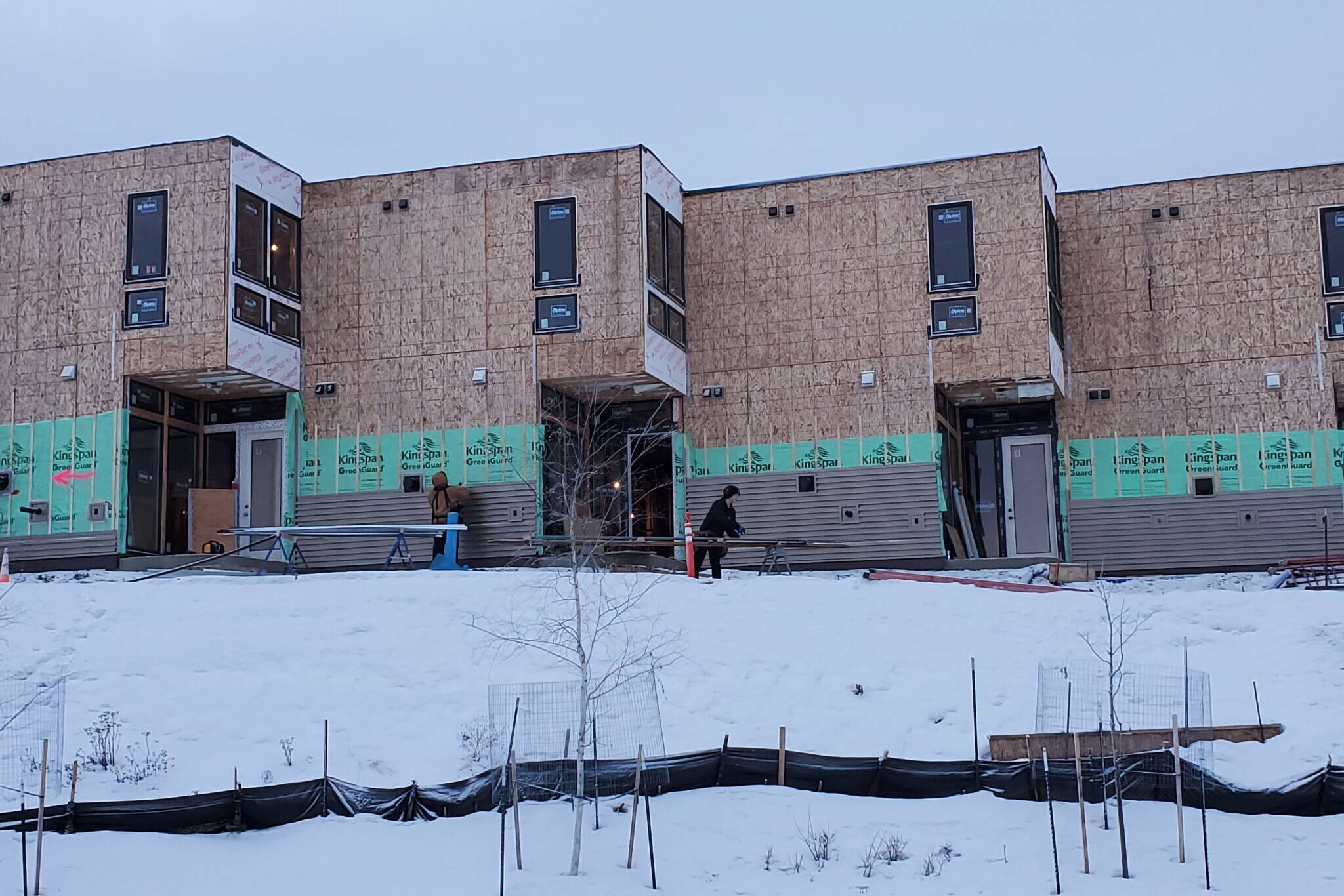 Construction workers attend to outdoor tasks on Dec. 17, 2024, at a residential project being built in downtown Anchorage. Alaska is expected to gain 1,500 construction jobs this year, according to the annual forecast published by state Department of Labor and Workforce Development economists. (Yereth Rosen/Alaska Beacon)