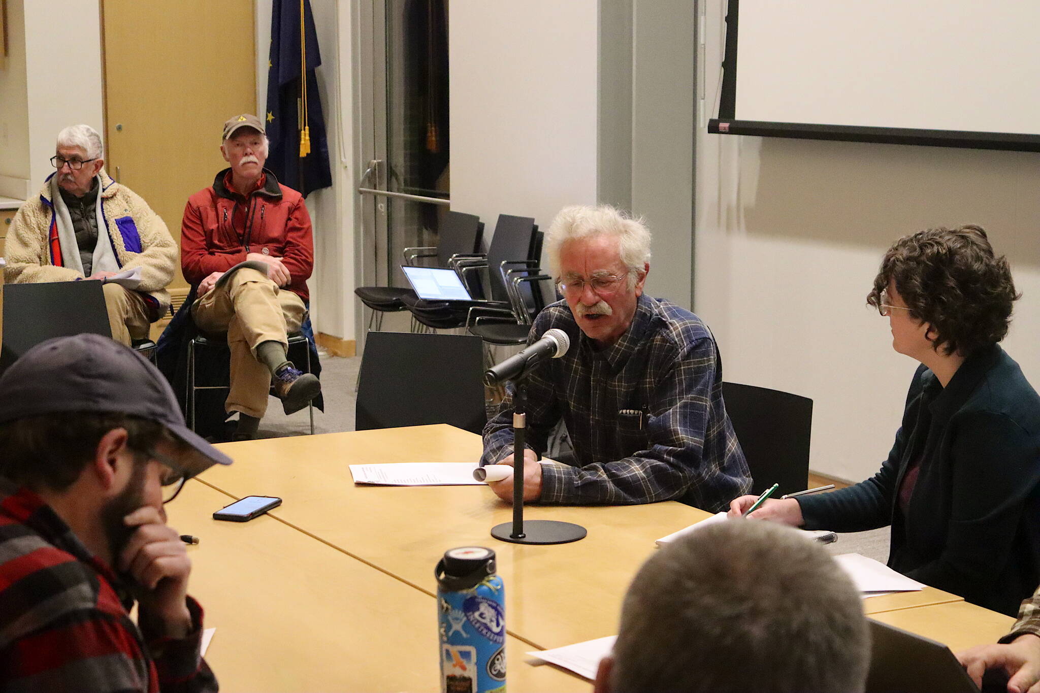 Dave Hanna (center), a former Eaglecrest Ski Area board member, addresses the current resort leaders during a board meeting Thursday night at the Mendenhall Valley Public Library. (Mark Sabbatini / Juneau Empire)