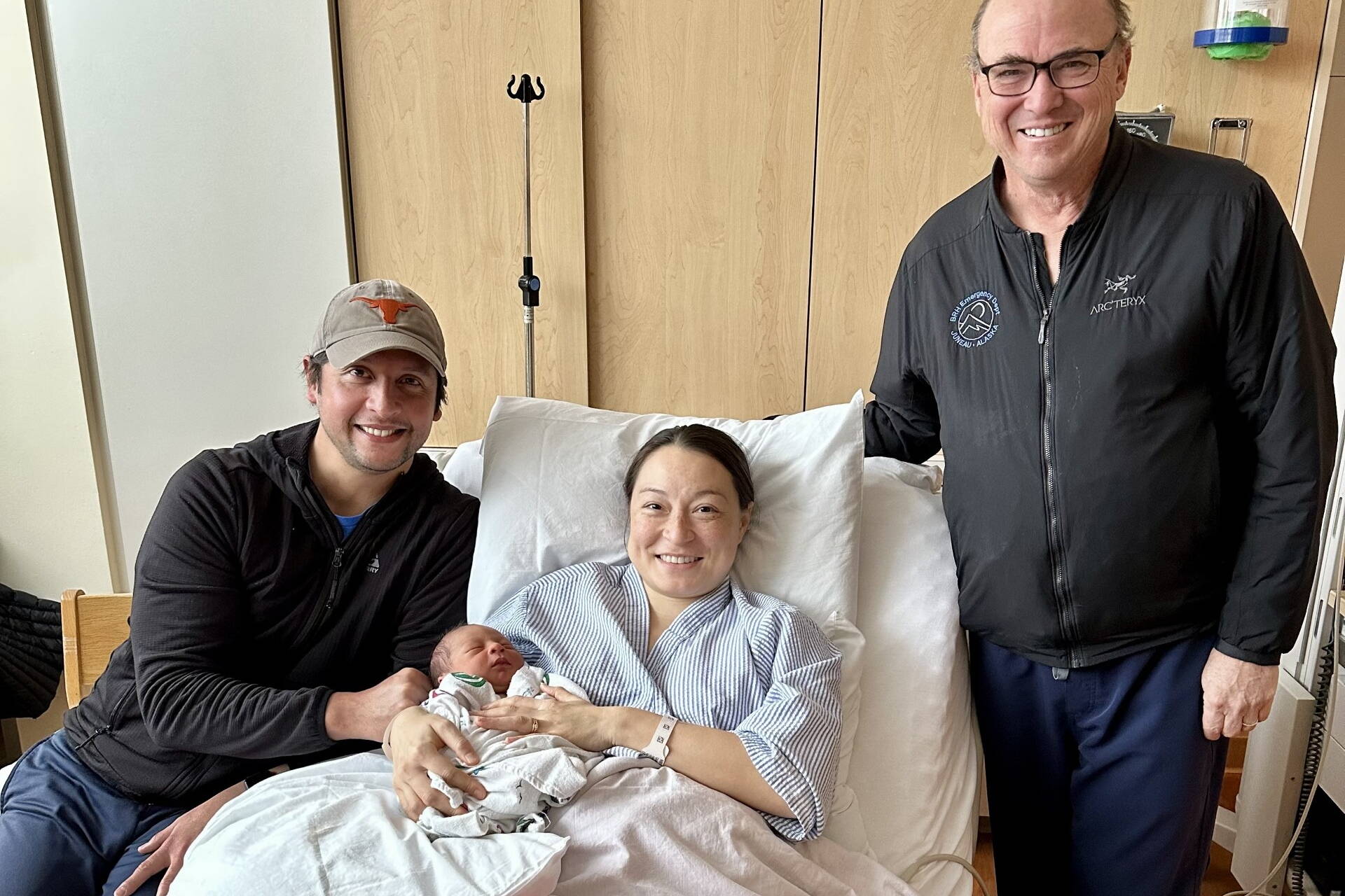 Koko Urata and Enrique Bravo with their baby, Enrique, the first born at Bartlett Regional Hospital in 2025, and Lindy Jones, a doctor at the hospital who with his wife made a wooden rocker as a gift for the new family. (Bartlett Regional Hospital photo)