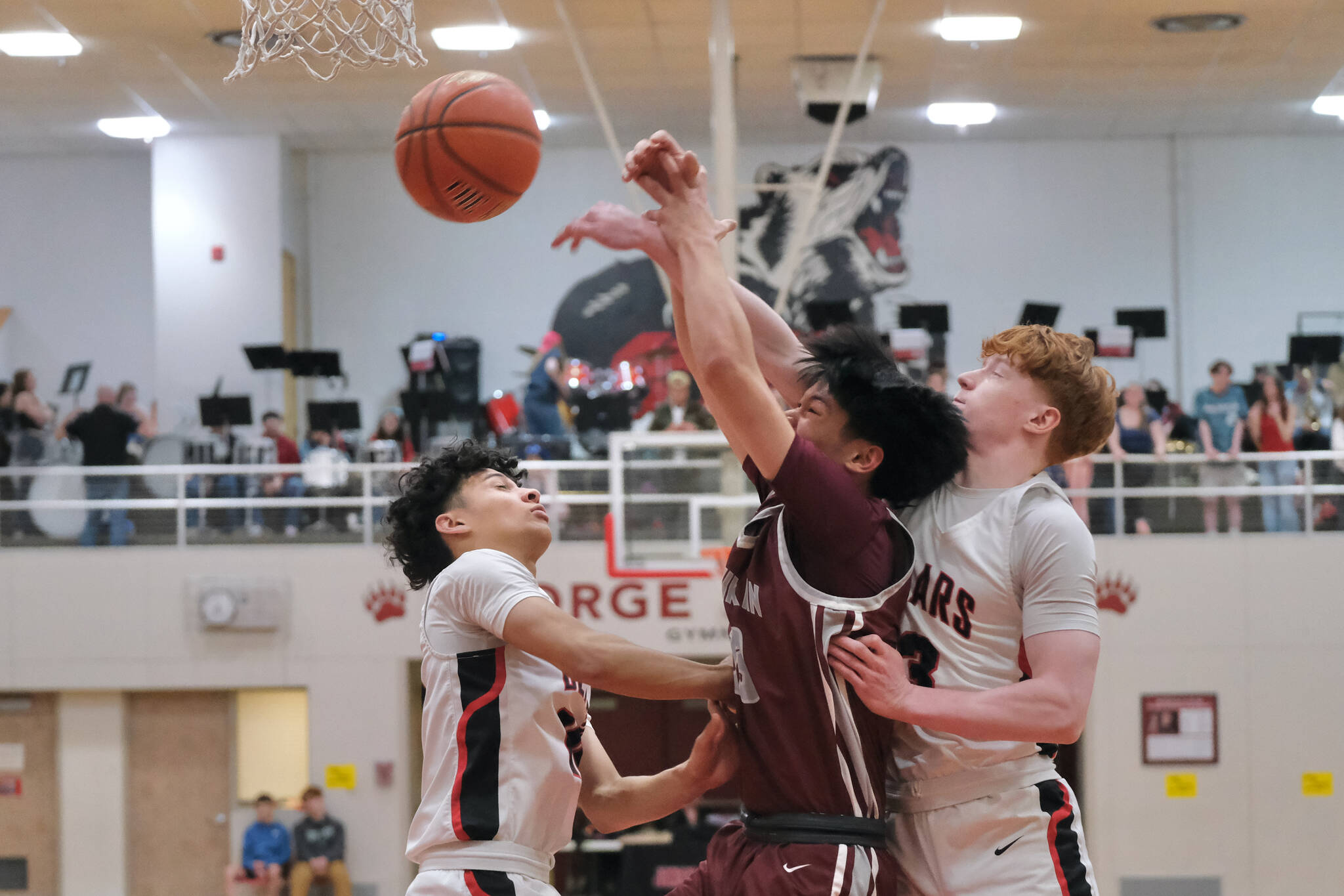 Juneau-Douglas High School: Yadaa.at Kalé senior Pedrin Saceda-Hurt, Ketchikan sophomore Zyrus Manabat and JDHS senior Gavin Gerrin battle for a rebound during the Crimson Bears 52-48 loss to the Kings on Friday at the George Houston Gymnasium in Juneau. (Klas Stolpe / Juneau Empire)