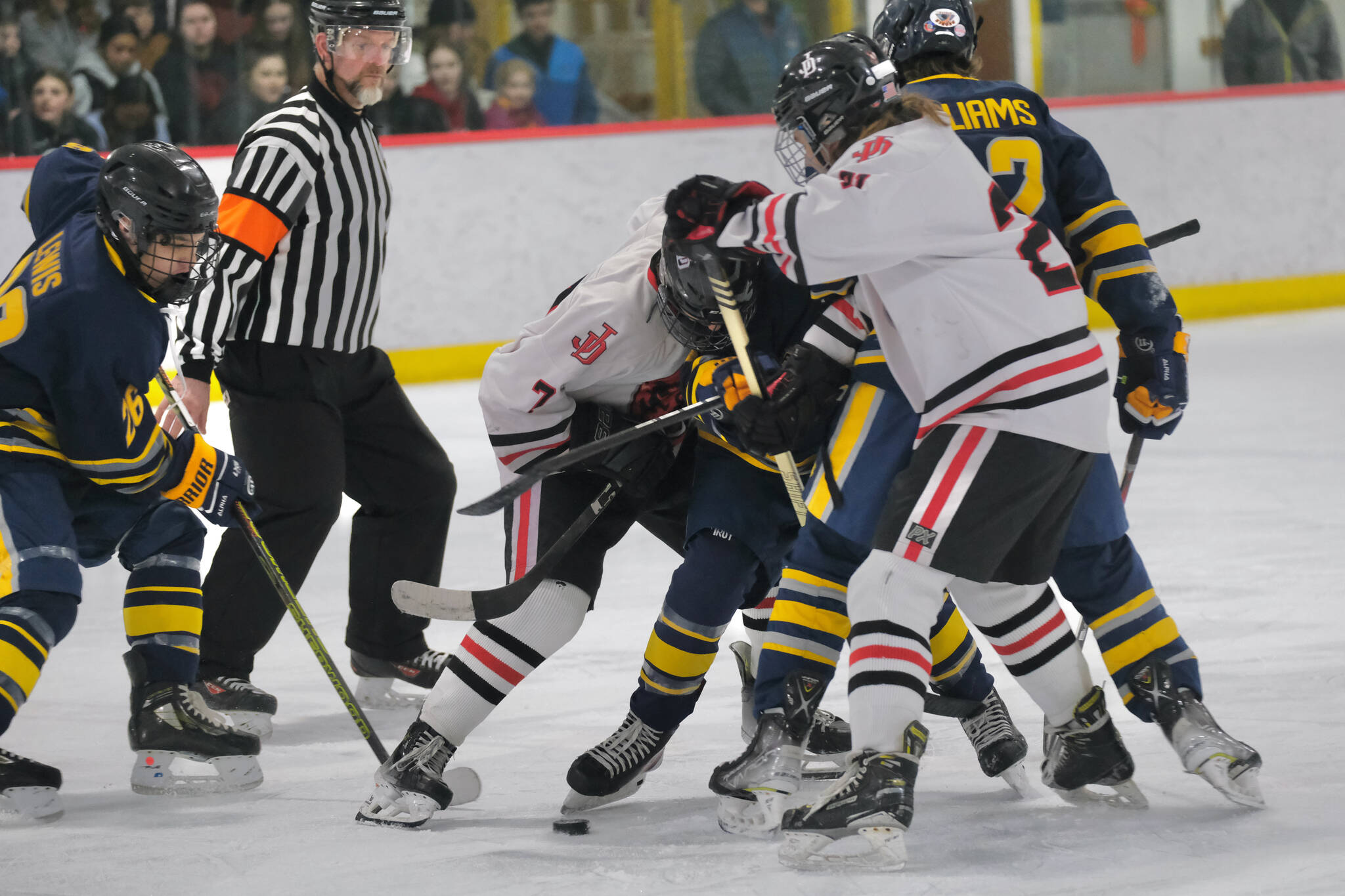 Juneau-Douglas High School: Yadaa.at Kalé hockey players and Bartlett High School hockey players work for a puck during the Crimson Bears 10-6 win over the Golden Bears Saturday at the Treadwell Ice Arena. (Klas Stolpe / Juneau Empire file photo)