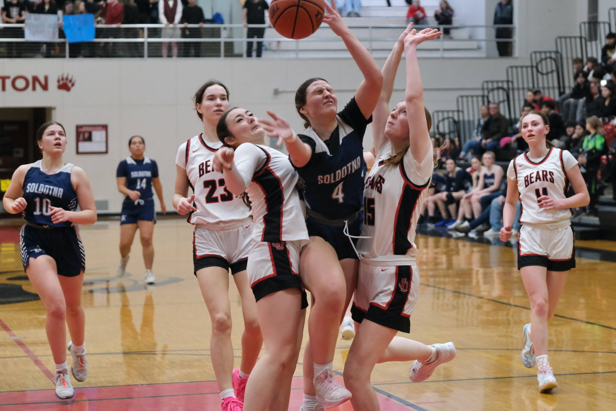 Juneau-Douglas High School: Yadaa.at Kalé sophomore Layla Tokuoka and freshman Lydia Goins (15) defend Soldotna senior Anika Jedlicka (4) as JDHS senior Cailynn Baxter (23) and junior Gwen Nizich (11) follow the play during the Crimson Bears 65-28 win over the Stars on Friday at the George Houston Gymnasium. (Klas Stolpe / Juneau Empire)