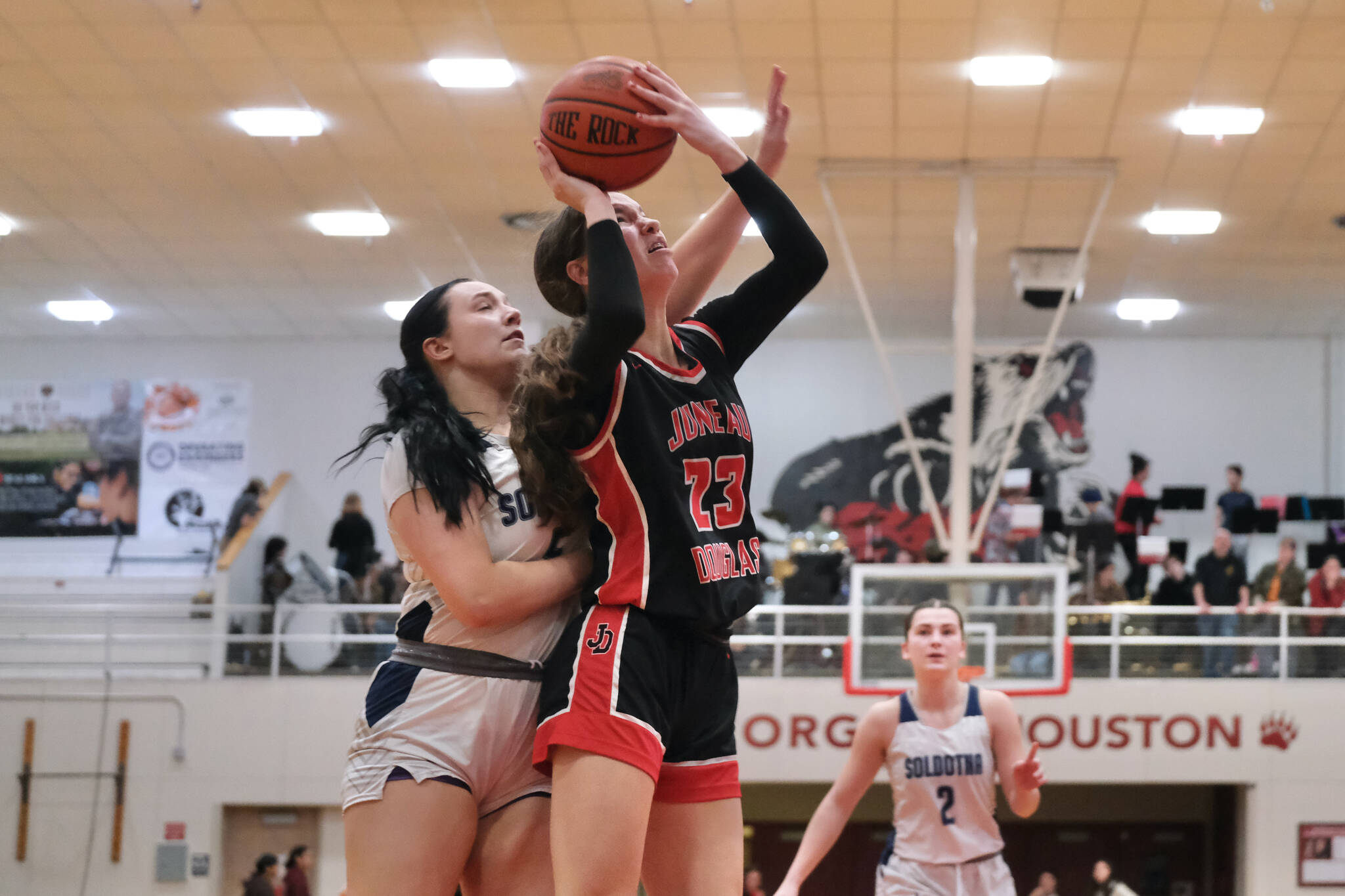 Juneau-Douglas High School: Yadaa.at Kalé senior Cailynn Baxter (23) is fouled by Soldotna senior Brooke Walters during the Crimson Bears 63-26 win over the Stars on Saturday at the George Houston Gymnasium. (Klas Stolpe / Juneau Empire)