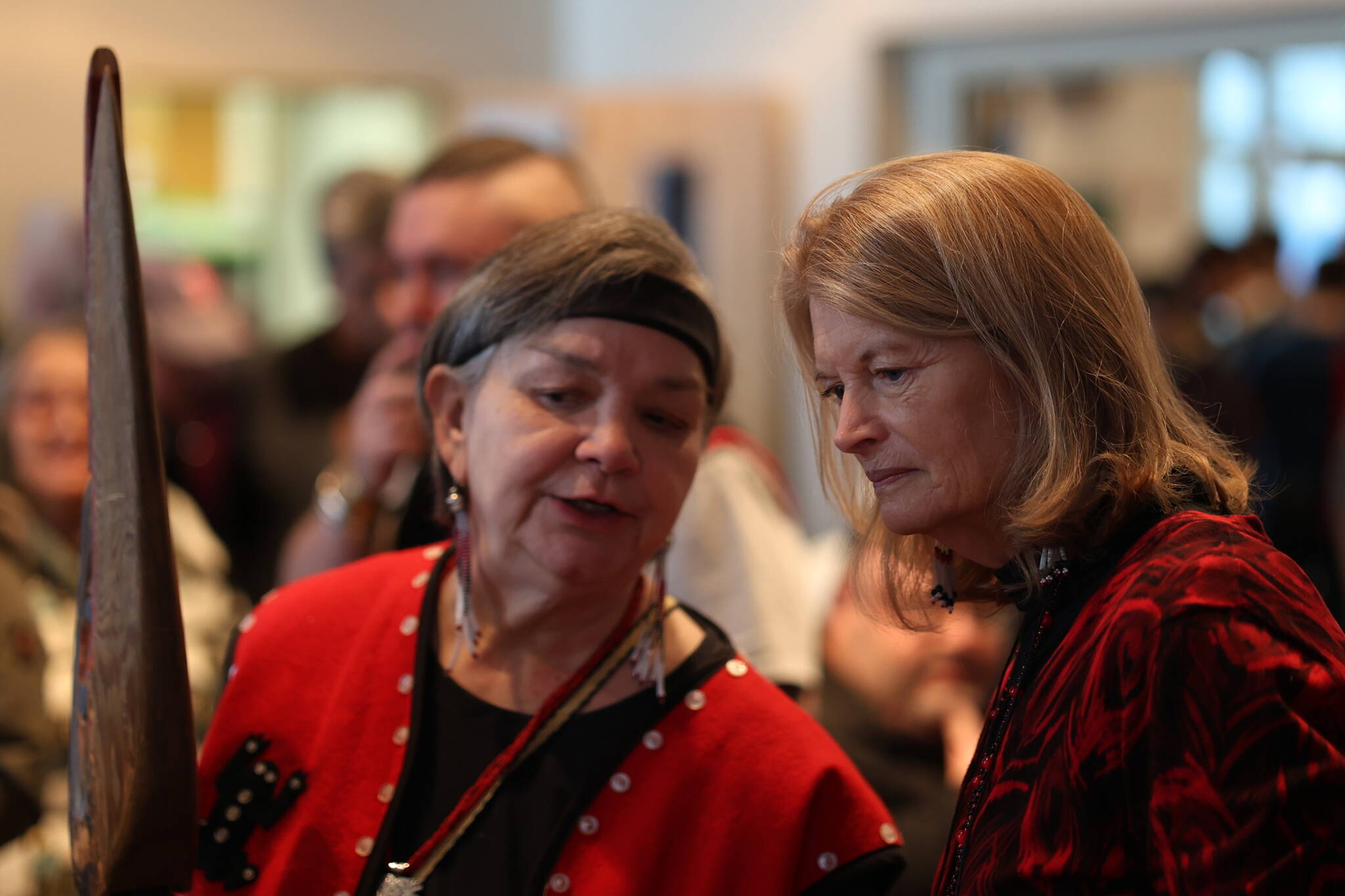 Alaska U.S. Sen. Lisa Murkowski (right) listens to Katherine George-Byrd ahead of Saturday’s bombardment apology ceremony. George-Byrd, a Kiks’adi clan mother, talked to the senator about the at.óow on the table before them. At.óow are clan items that provide a connection between current clan members and their ancestors. (Sam Pausman / Wrangell Sentinel)