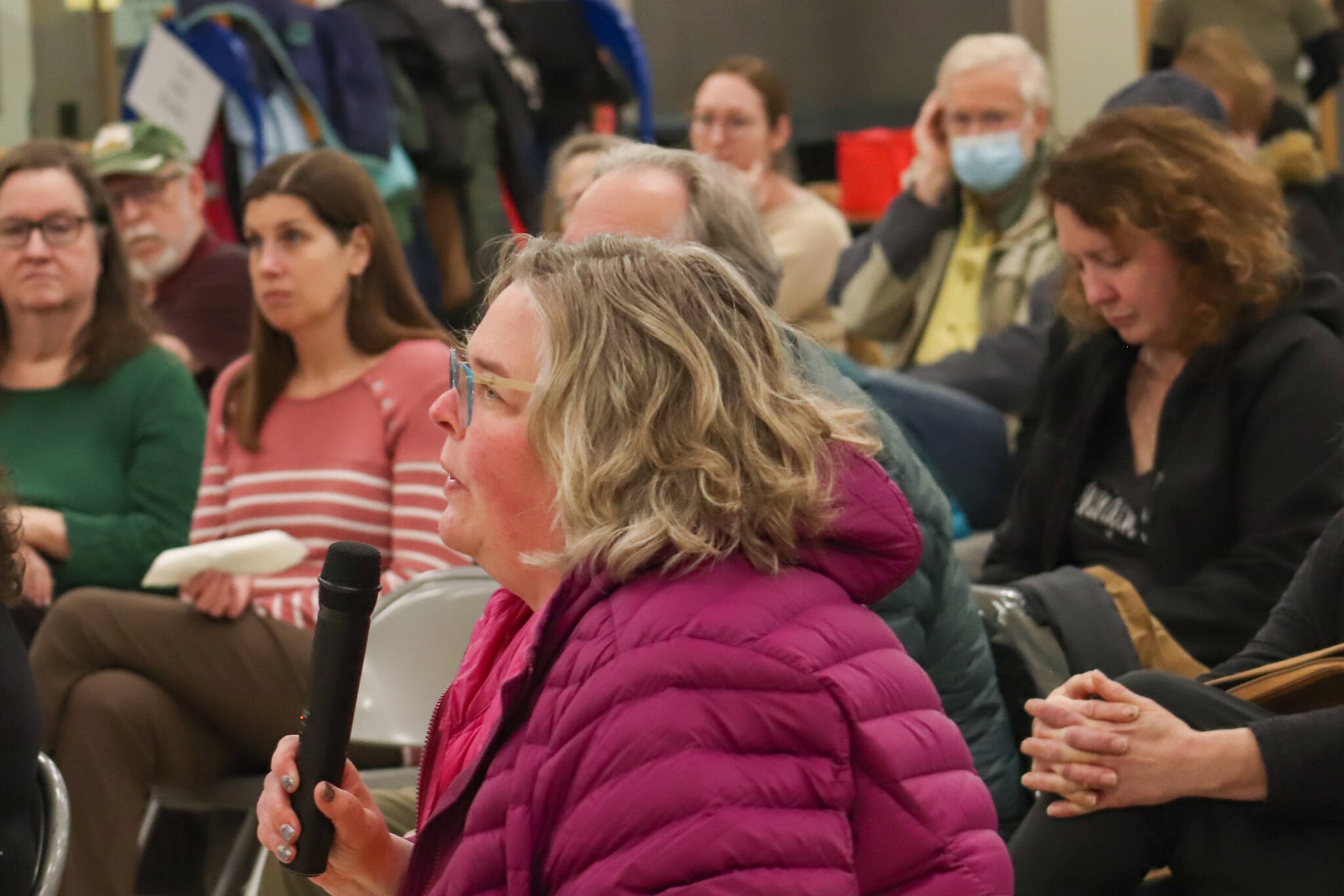 Kristin Garot asks a question to members of Juneau’s legislative delegation at a town hall in the Dzantik’i Heeni school commons on Monday, Jan. 13, 2025. (Jasz Garrett / Juneau Empire)