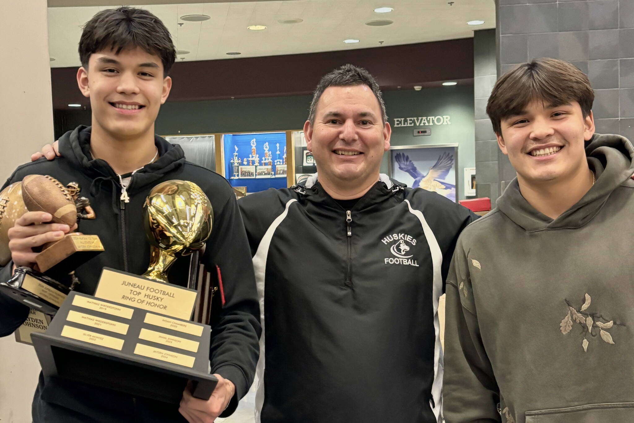 Juneau Huskies Ring of Honor winner Jayden Johnson, left, stands with Juneau coach Rich Sjoroos and brother Jamal Johnson after the Huskies award banquet. Jamal Johnson is a 2023 Thunder Mountain High School graduate and also a Ring of Honor recipient. He is currently playing for Fort Lewis College in Durango, Colorado. (Photo courtesy Juneau Huskies)