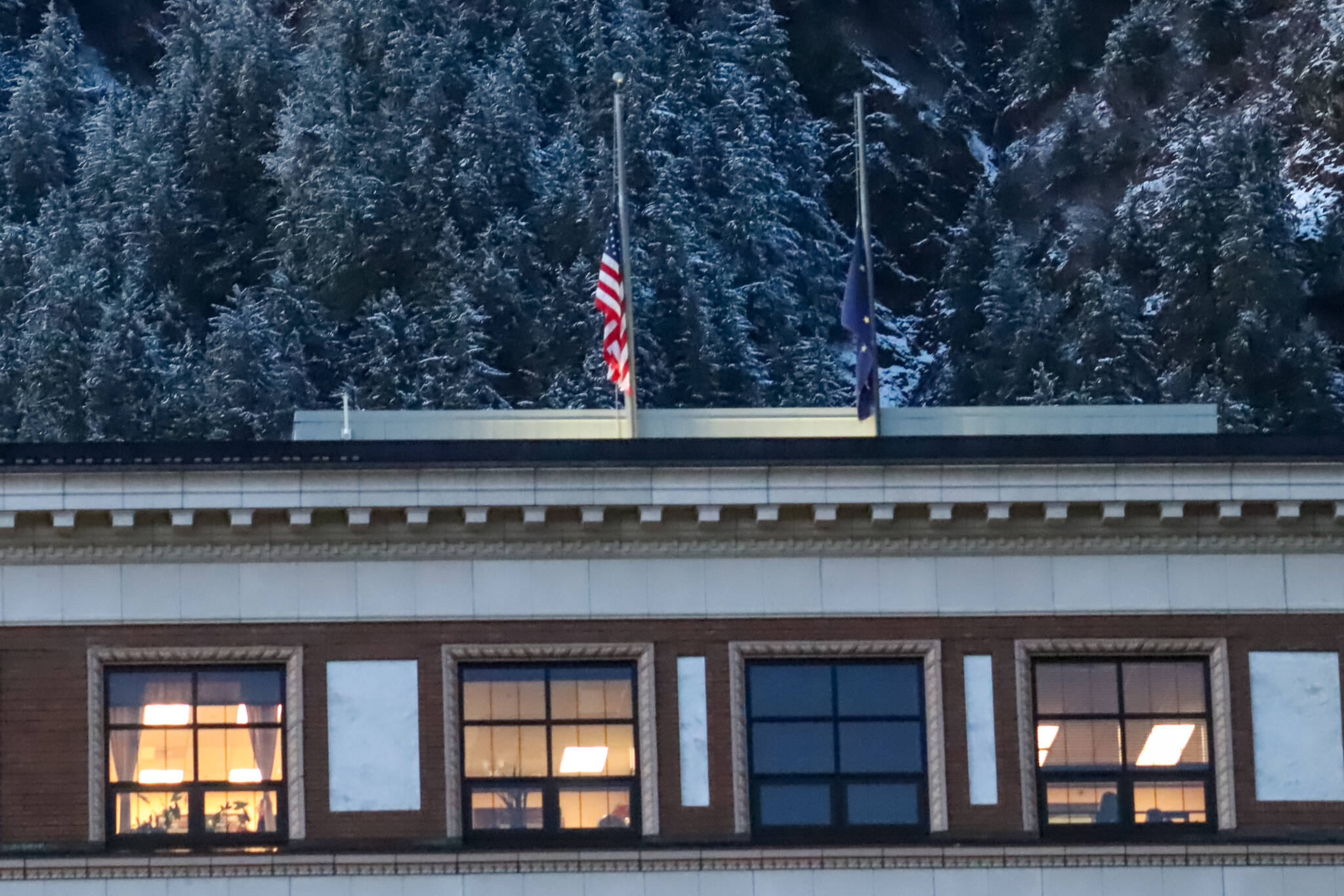 Flags fly at half staff at the Alaska State Capitol on Thursday. (Jasz Garrett / Juneau Empire)