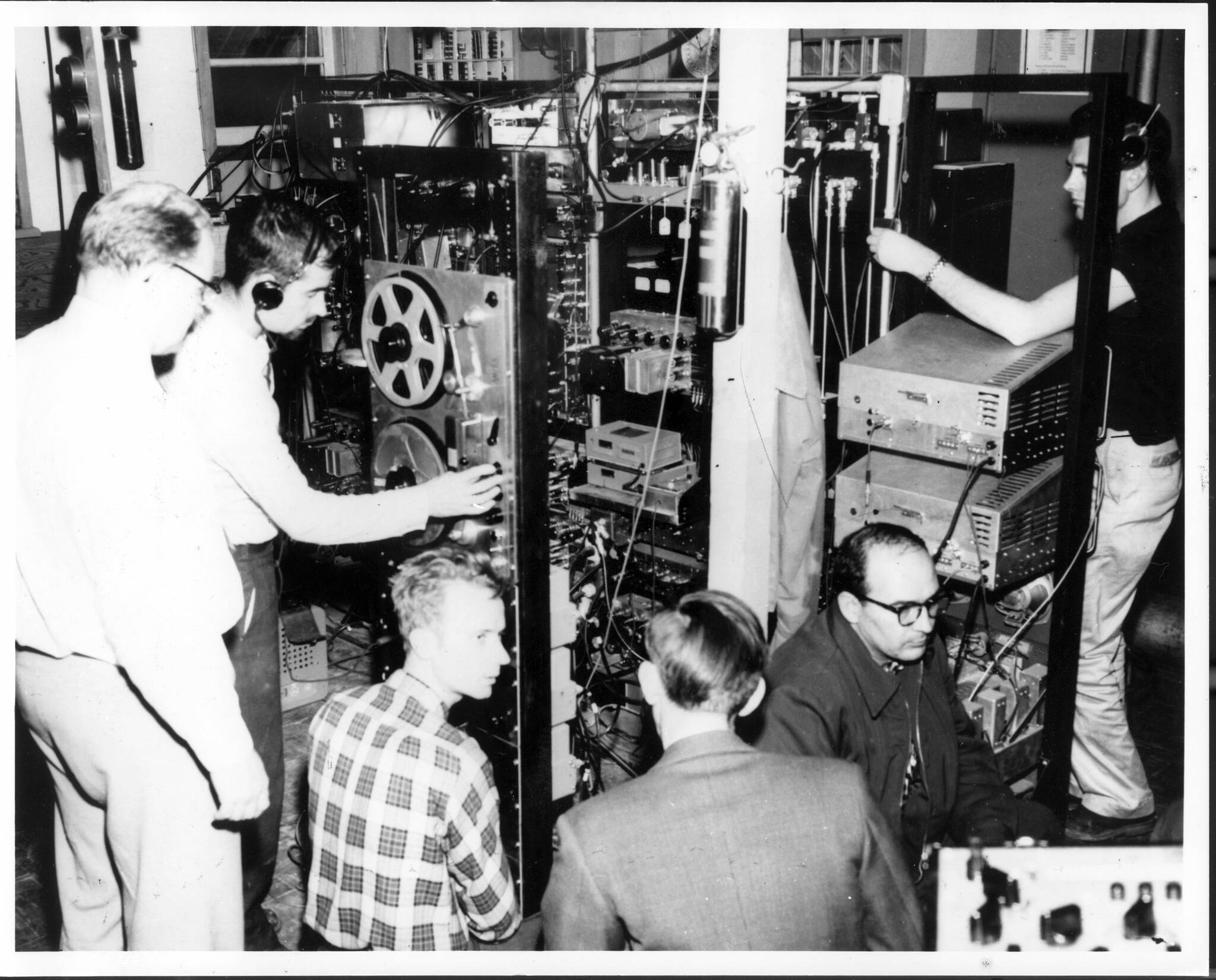 In October 1957, researchers from the Geophysical Institute track the Sputnik 1 satellite In the Ballaine Lake Tracking Station on the UAF campus. From left are Bob Merritt, Joe Pope, Pete Michelow, Gordon Little, Glen Stanley and Ernest Stiltner. (Photo courtesy Geophysical Institute)