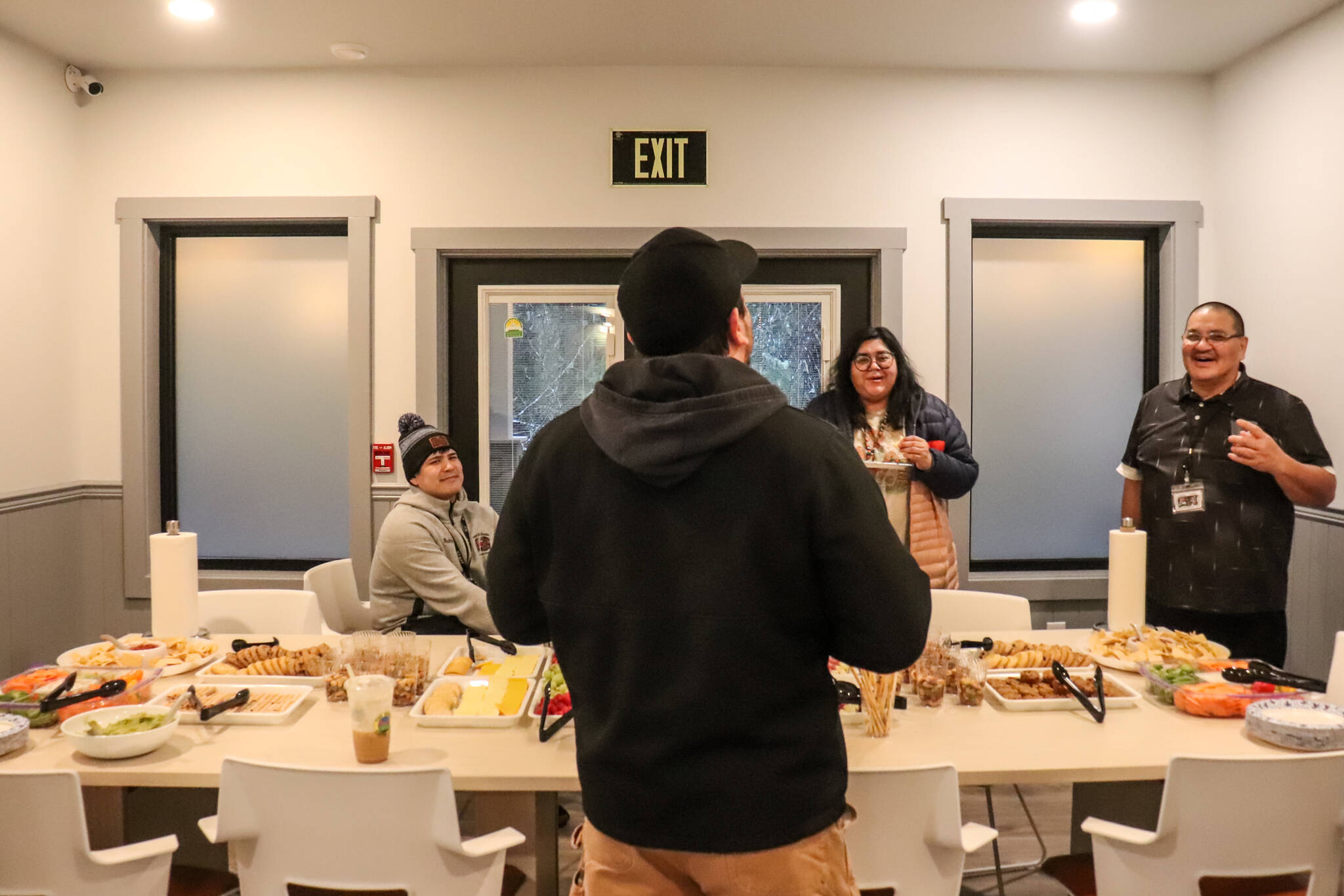 Staff from Tlingit and Haida enjoy refreshments in Haven House’s dining room on Tuesday during an open house. (Jasz Garrett / Juneau Empire)