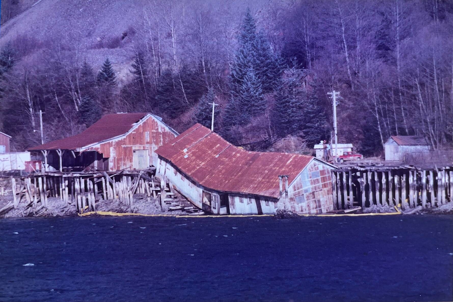 By the early 1980s, the docks and buildings of the Alaska-Juneau Gold Mine were deteriorating. One of the warehouses collapsed and fell into the channel. (Laurie Craig / Juneau Empire)