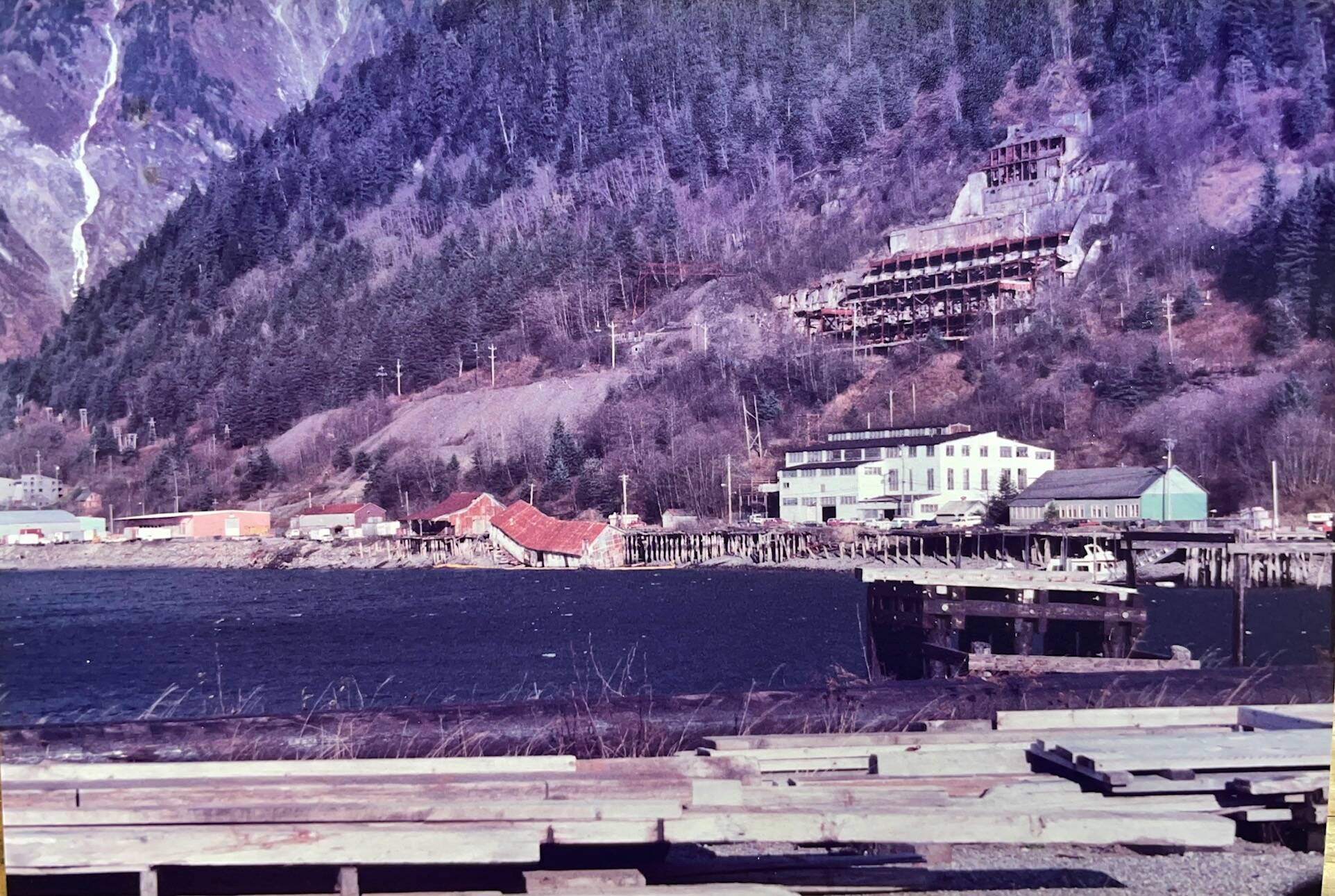 By the early 1980s, the docks and buildings of the Alaska-Juneau Gold Mine were deteriorating. One of the warehouses collapsed and fell into the channel. (Laurie Craig / Juneau Empire)