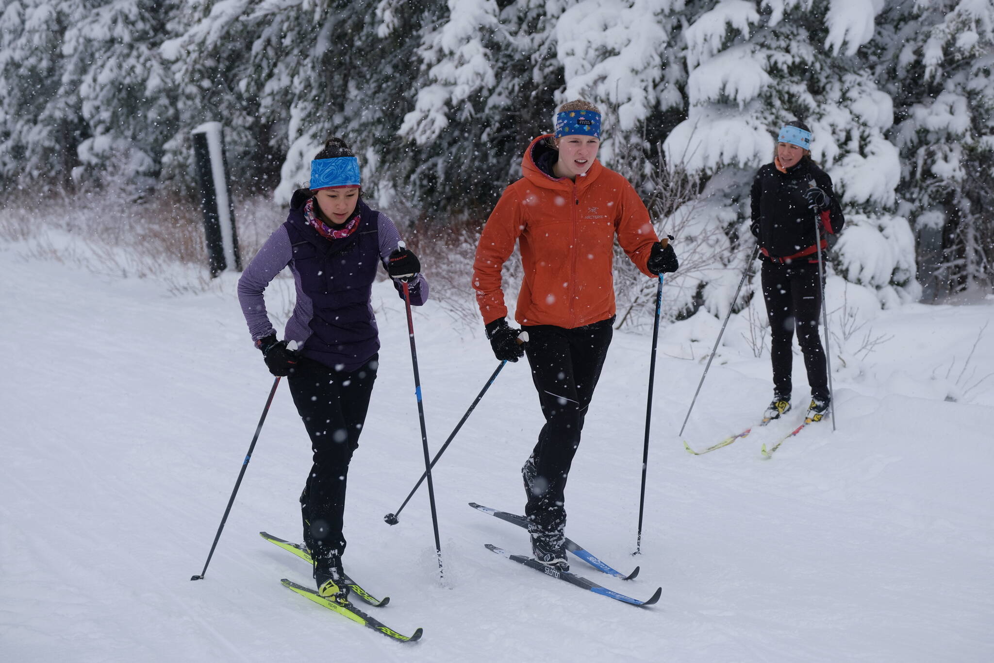 Juneau-Douglas High School: Yadaa.at Kalé Nordic Ski team junior Lua Mangaccat and senior Ida Meyer work classic style uphill repeats during practice Saturday at Eaglecrest as coach Abby McAllister looks on. (Klas Stolpe / Juneau Empire)