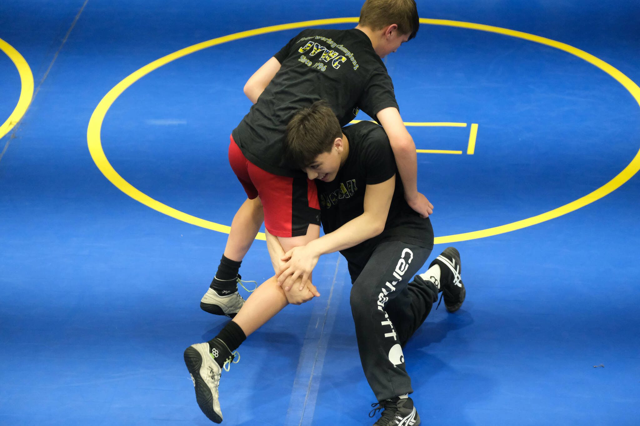 Thunder Mountain Middle School seventh grader Andrew Erickson and eighth grader Landon Hill practice a technique during a three-day wrestling clinic at the Juneau Wrestling Center on Monday. The clinic was taught by Askren Wrestling Academy coach Wilder Wichman. (Klas Stolpe / Juneau Empire)