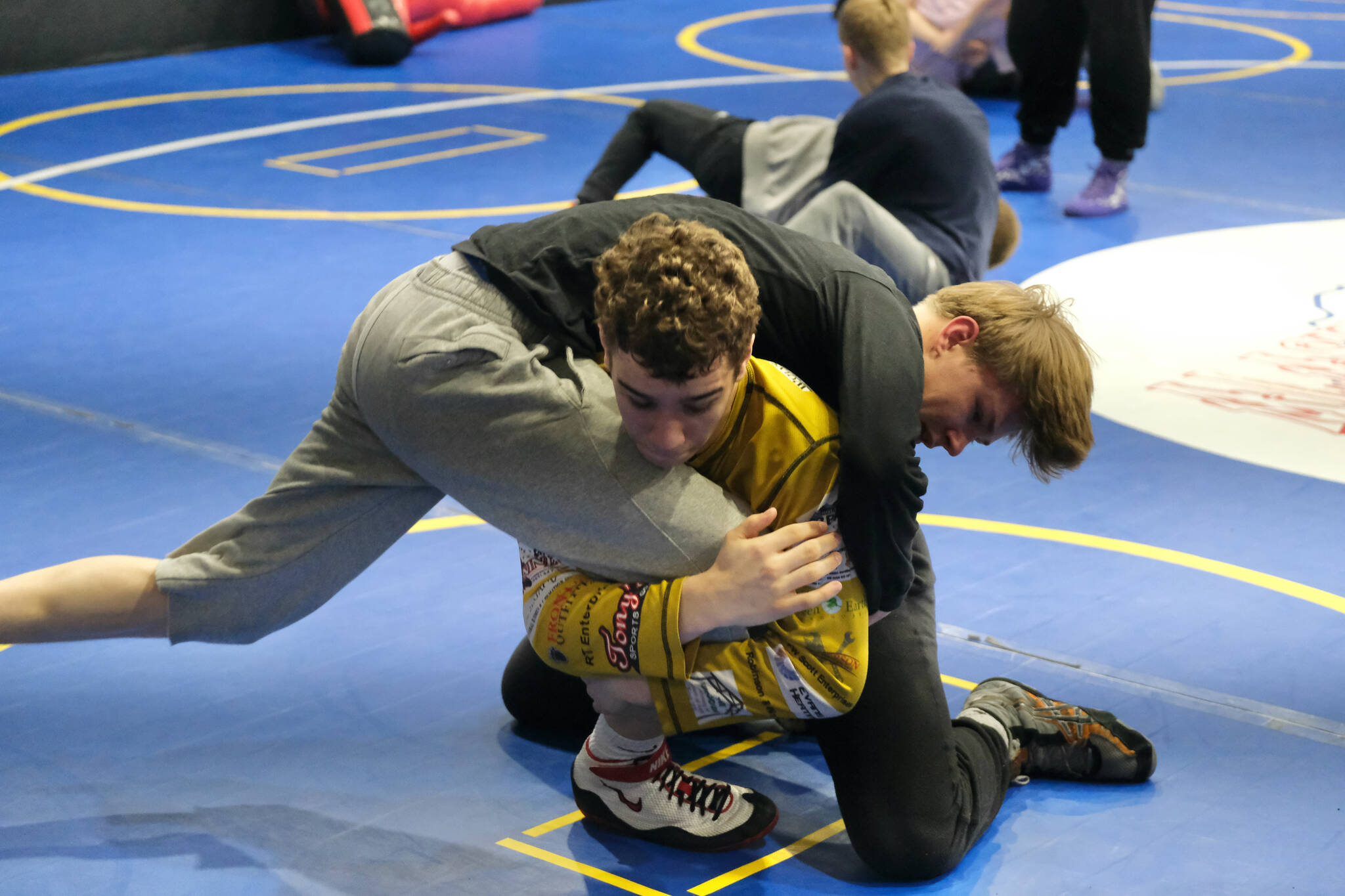 Juneau-Douglas High School: Yadaa.at Kalé sophomore Jed Davis works a technique with junior Marlin Cox on Monday during a three-day wrestling clinic at the Juneau Wrestling Center led by Askren Wrestling Academy coach Wilder Wichman. (Klas Stolpe / Juneau Empire)