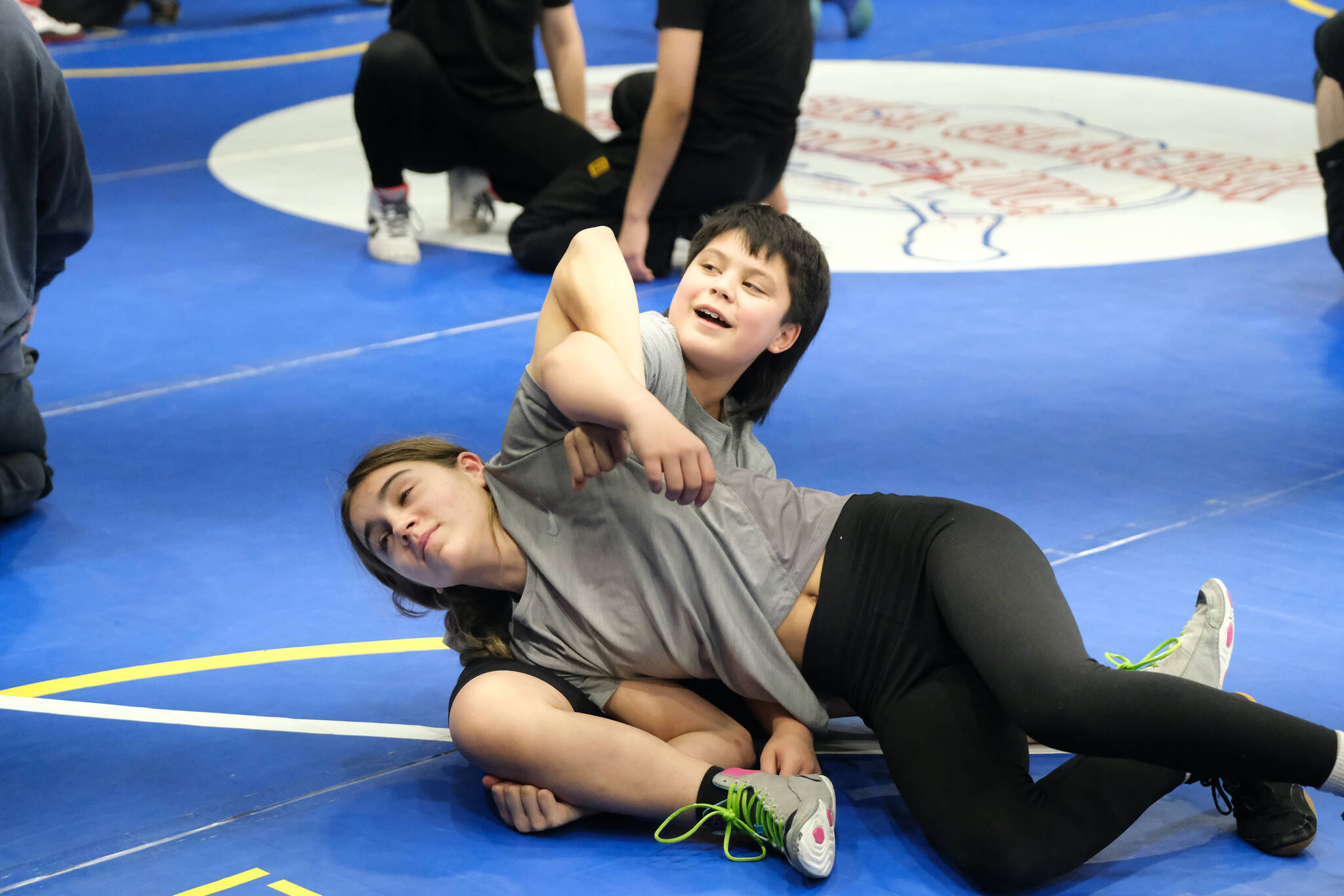 Thunder Mountain Middle School student Minali Reid works a technique with Cash Miller on Monday during a three-day wrestling clinic at the Juneau Wrestling Center led by Askren Wrestling Academy coach Wilder Wichman. (Klas Stolpe / Juneau Empire)