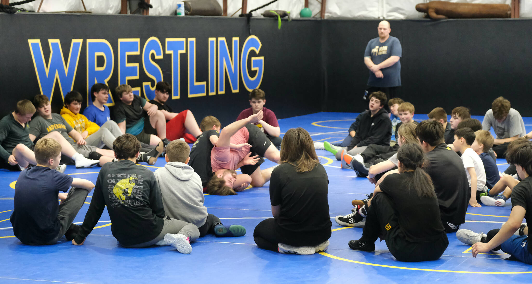 Askren Wrestling Academy coach Wilder Wichman demonstrates a technique on Monday during a three-day wrestling clinic at the Juneau Wrestling Center. (Klas Stolpe / Juneau Empire)