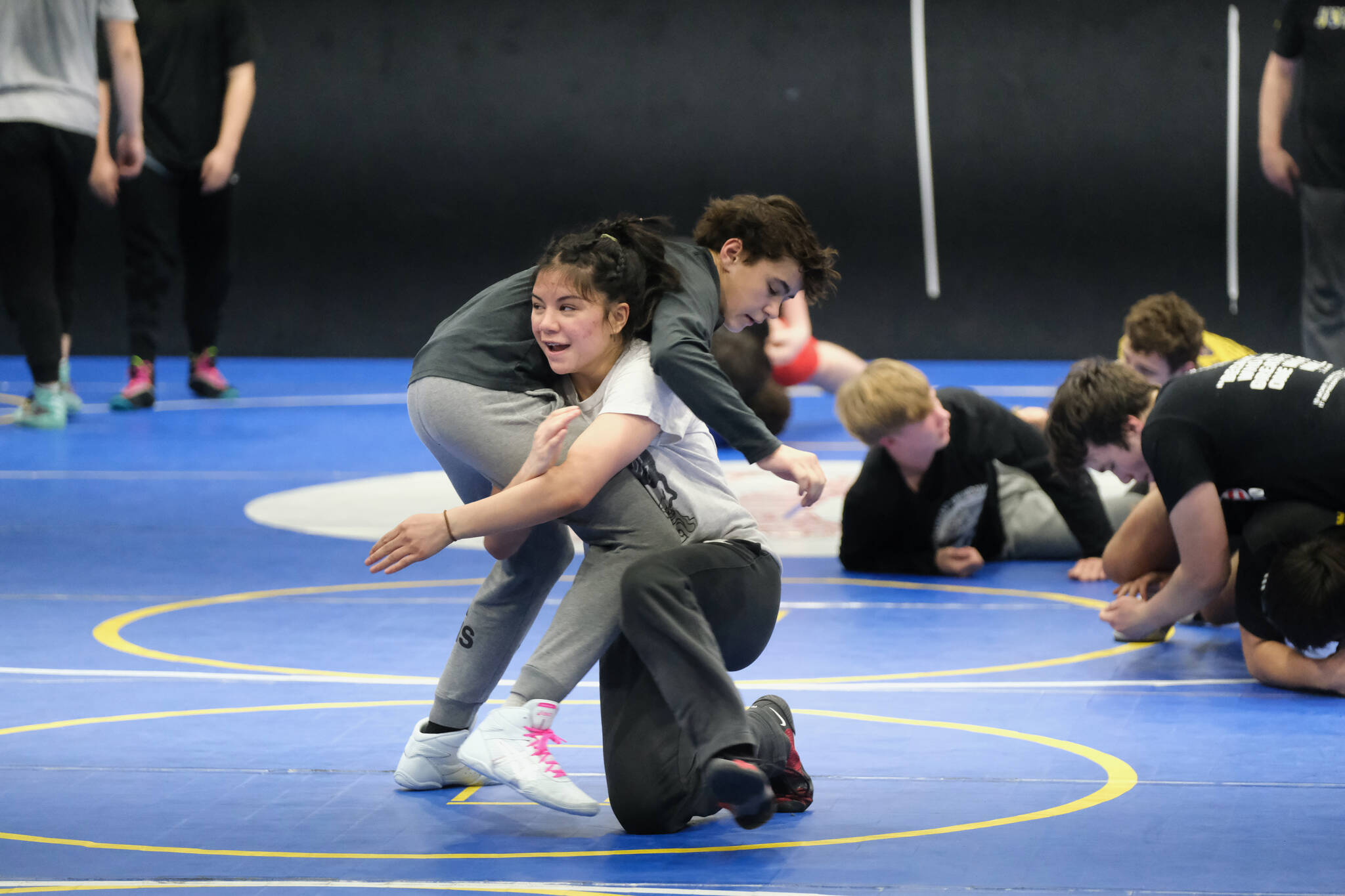 Juneau-Douglas High School: Yadaa.at Kalé freshman Nixie Schooler works a technique with TMMS eighth grader Jack Pegues on Monday during a three-day wrestling clinic at the Juneau Wrestling Center led by Askren Wrestling Academy coach Wilder Wichman. (Klas Stolpe / Juneau Empire)