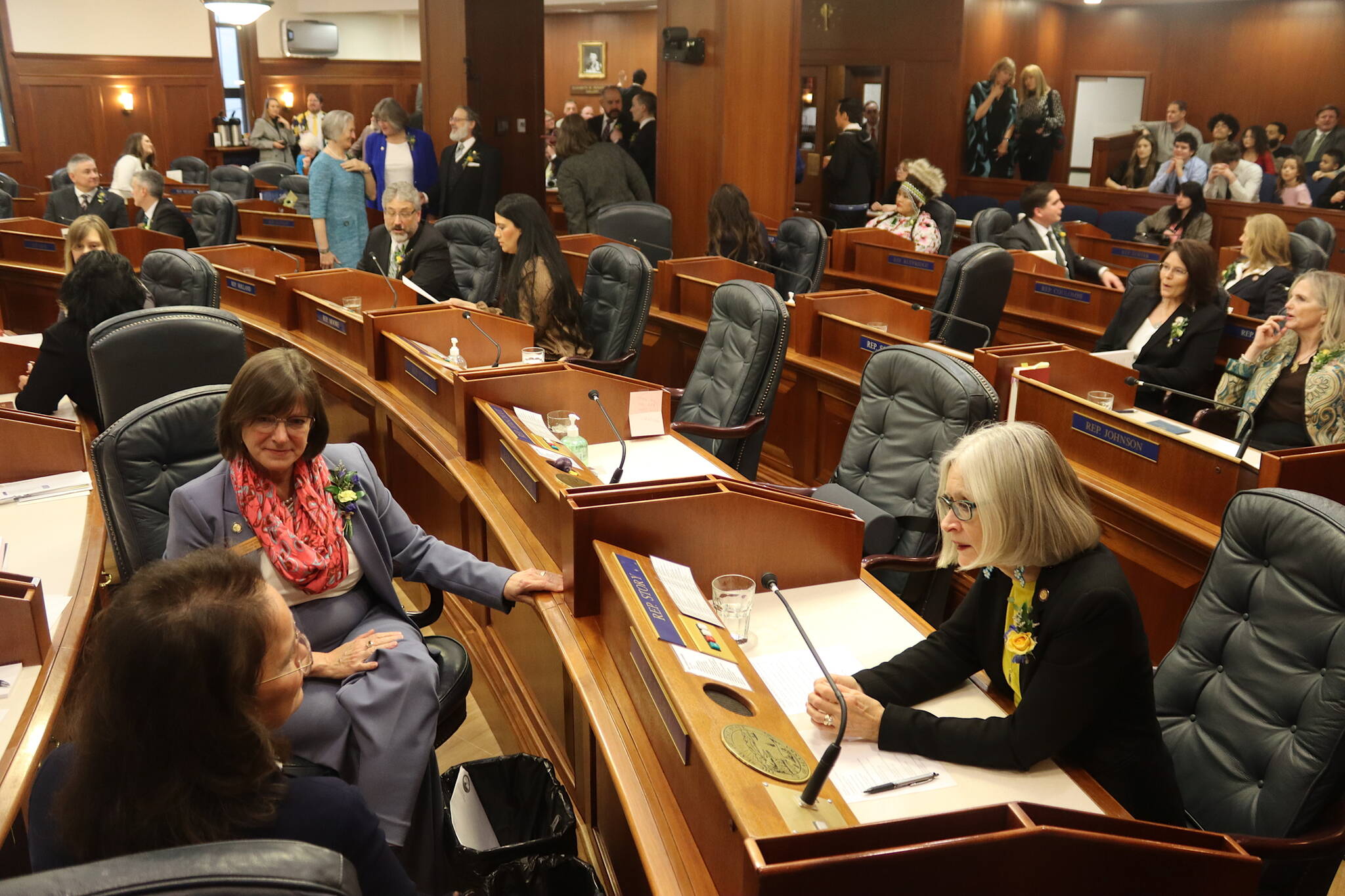 State Rep. Andi Story (D-Juneau), right, talks with Reps. Sarah Vance (R-Homer), left, and Rep. Alyse Galvin (I-Anchorage) before the House gavels in on the opening day of the 34th Alaska State Legislature on Tuesday at the Alaska State Capitol. (Mark Sabbatini / Juneau Empire)