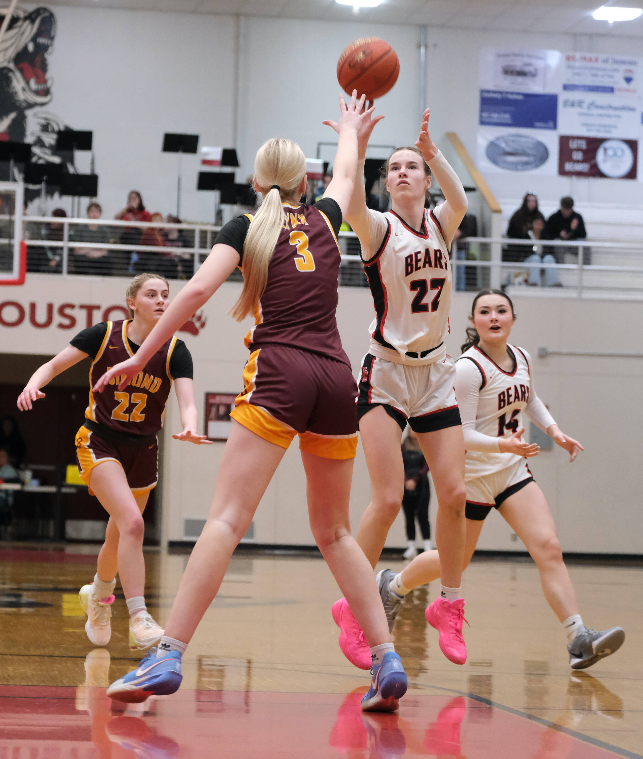 Juneau-Douglas High School: Yadaa.at Kalé senior Kerra Baxter (22) scores over Dimond senior Evan Hamey (3) during Friday’s Crimson Bears 62-48 win over the Lynx inside the George Houston Gymnasium. Dimond junior Katie MacDonald (22) and JDHS sophomore Layla Tokuoka (14) follow the play. The teams play Saturday at 7 p.m. (Klas Stolpe / Juneau Empire)