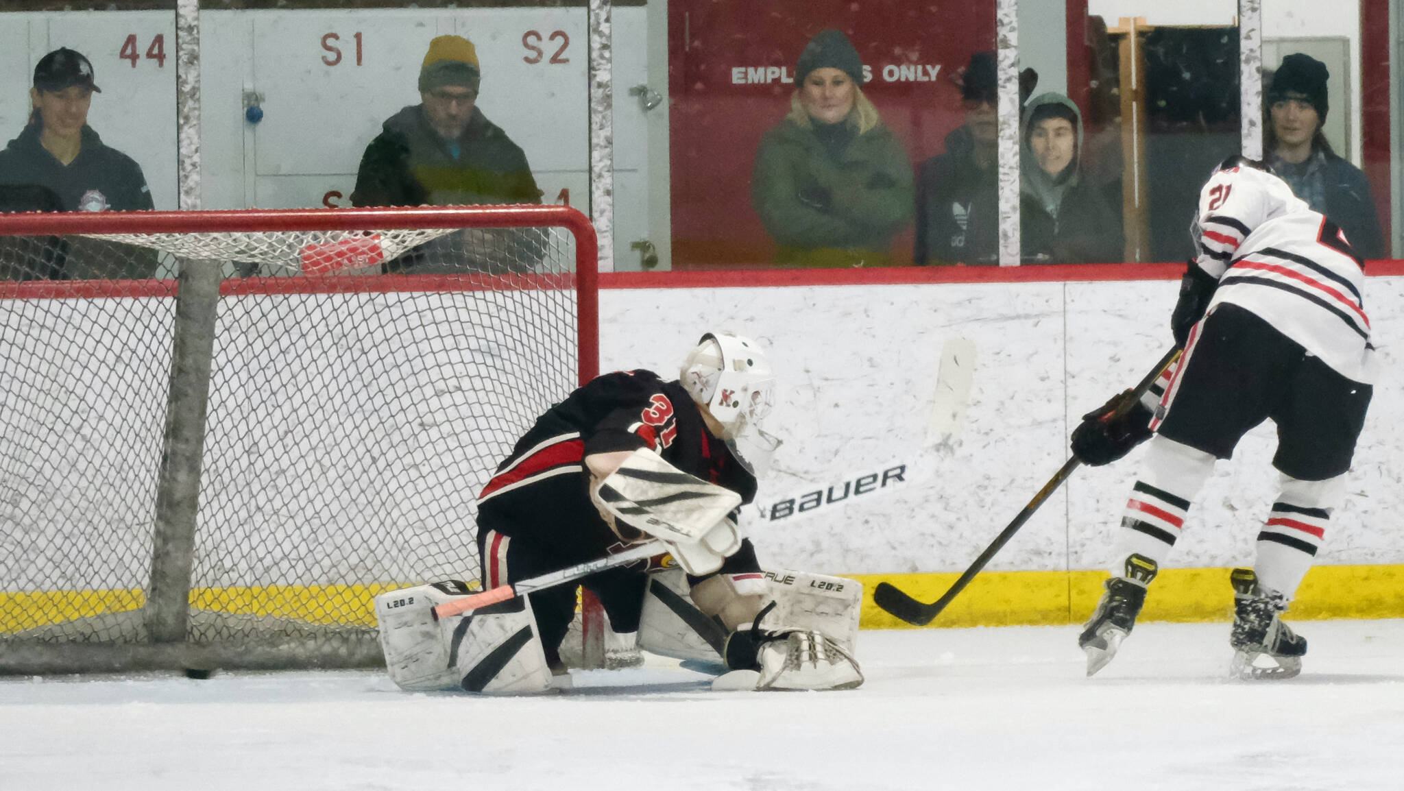 Juneau-Douglas High School: Yadaa.at Kalé sophomore Caden Morris puts a penalty shot goal in behind Kenai goalie Evyn Witt during the Crimson Bears’ 5-1 loss to the Kardinals on Saturday at Treadwell Ice Arena. (Klas Stolpe / Juneau Empire)