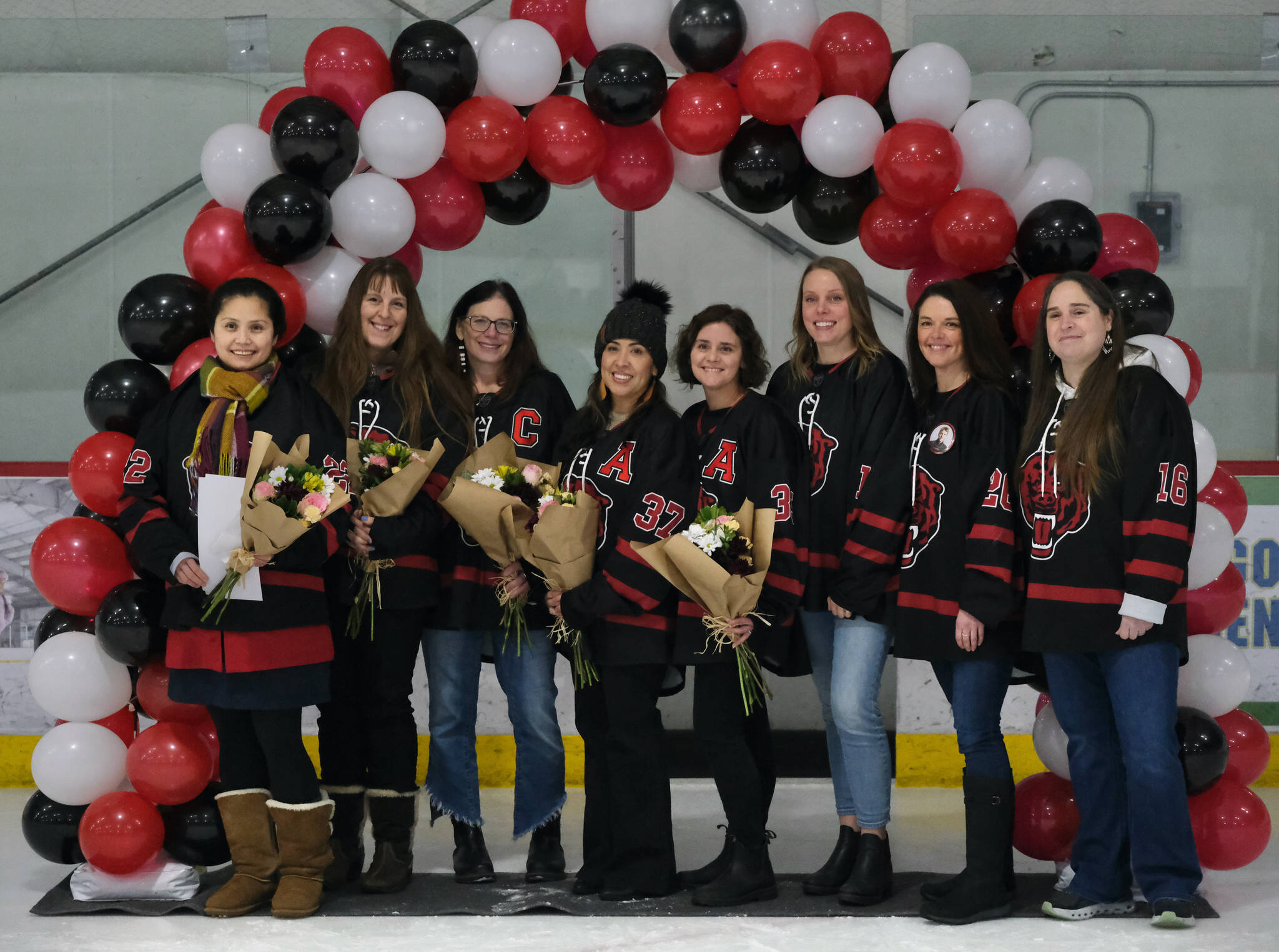 Mothers of Juneau-Douglas High School: Yadaa.at Kalé Crimson Bears seniors pose for a photo before Friday’s game against the visiting Kenai Kardinals at Treadwell Ice Arena. (Klas Stolpe / Juneau Empire)