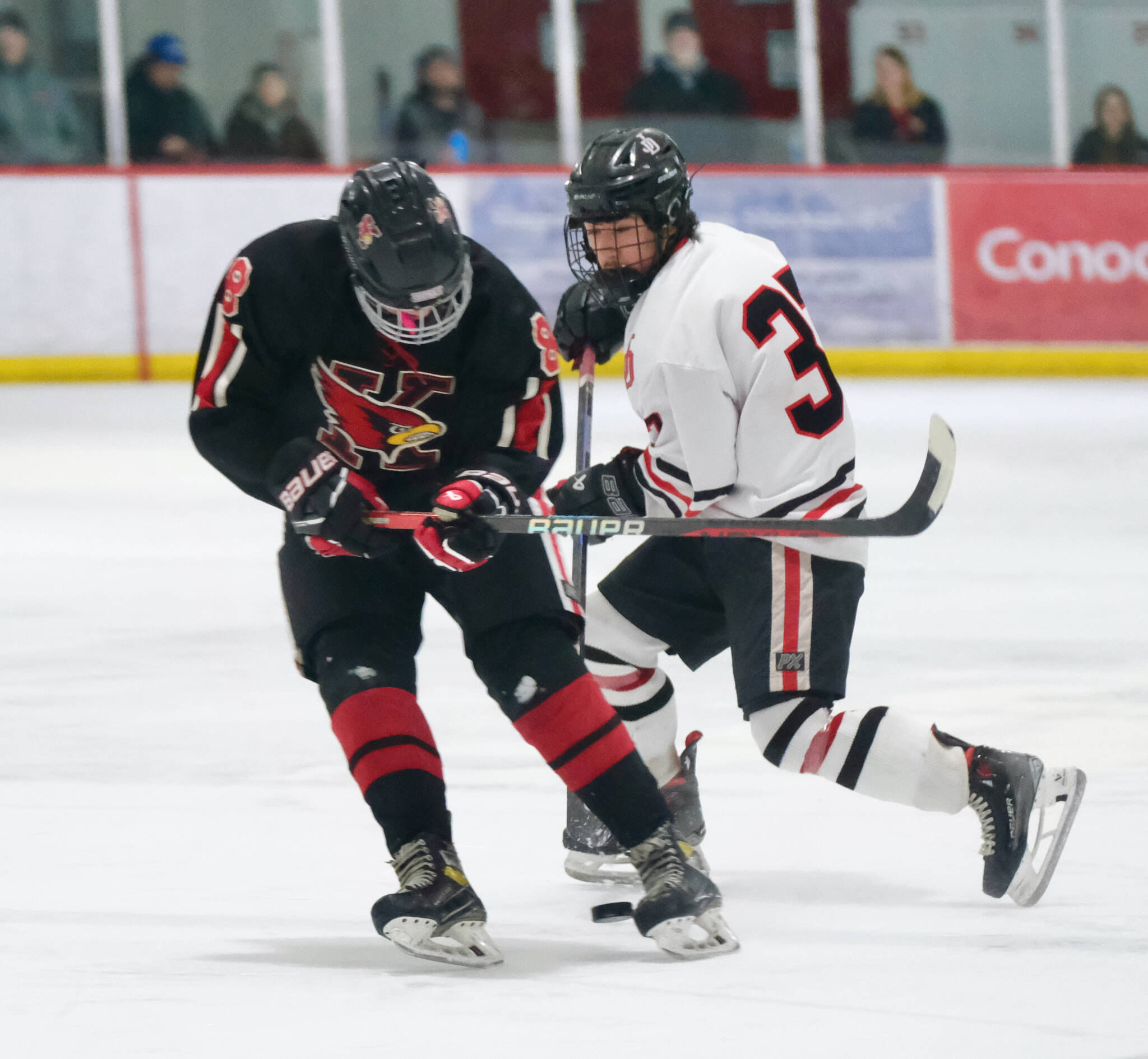 Juneau-Douglas High School: Yadaa.at Kalé senior Emilio Holbrook (37) moves a puck against Kenai’s Everett Chamberlain (8) during the Crimson Bears’ 5-1 loss to the Kardinals on Saturday at Treadwell Ice Arena. (Klas Stolpe / Juneau Empire)