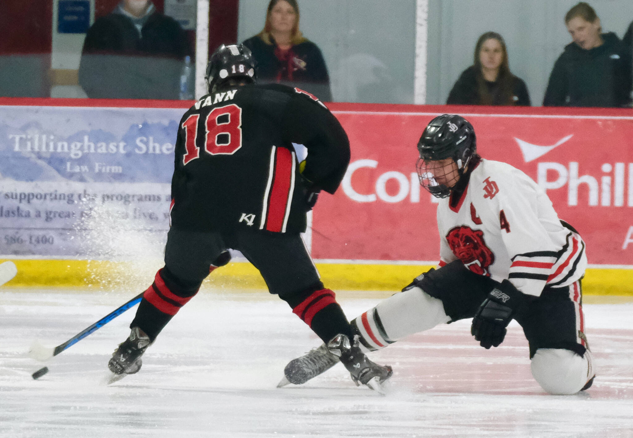 Juneau-Douglas High School: Yadaa.at Kalé senior Luke Bovitz (4) stops a shot by Kenai’s Sawyer Vann, despite losing his stick, during the Crimson Bears 5-1 loss to the Kardinals on Saturday at Treadwell Ice Arena. (Klas Stolpe / Juneau Empire)