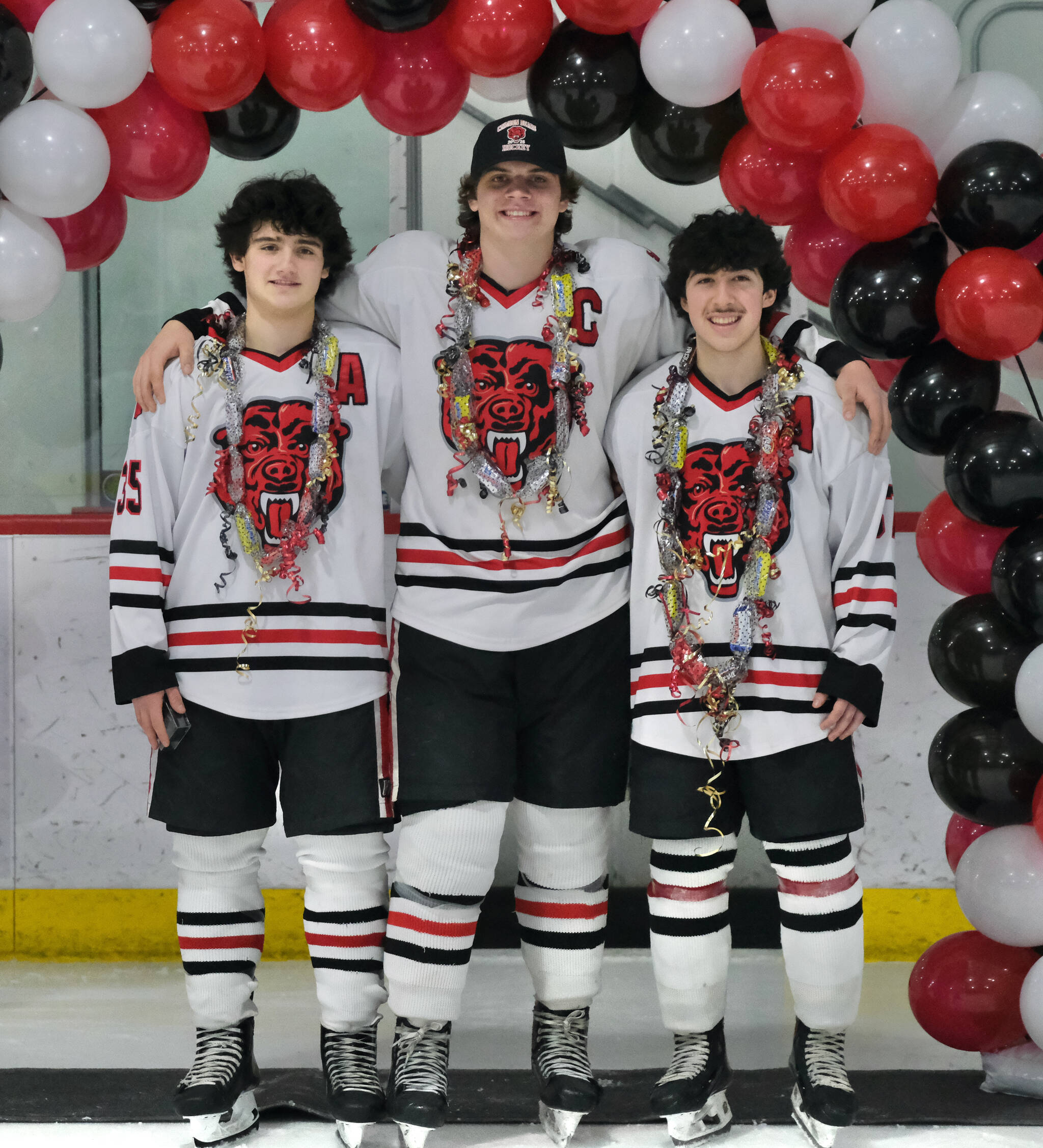 Juneau-Douglas High School: Yadaa.at Kalé senior co-captains Dylan Sowa (35), Luke Bovitz (4) and Emilio Holbrook pose during Friday senior night ceremonies at Treadwell Ice Arena. (Klas Stolpe / Juneau Empire)