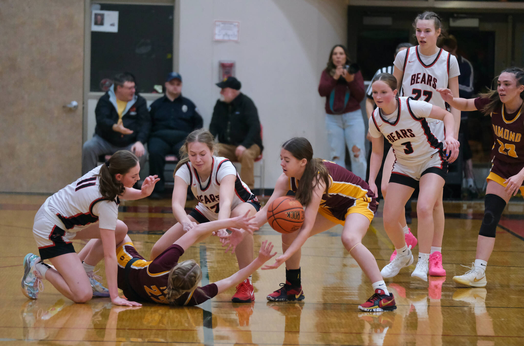 Juneau-Douglas High School: Yadaa.at Kalé junior Gwen Nizich (11), sophomore Bergen Erickson (12), junior Cambry Lockhart (3) and senior Kerra Baxter (22) and Dimond junior Katie MacDonlad (22), freshman Khloe Mack (5) and senior Sienna Pederson (23) react to a loose ball during the Crimson Bears 53-43 loss to the Lynx Saturday inside the George Houston Gymnasium.