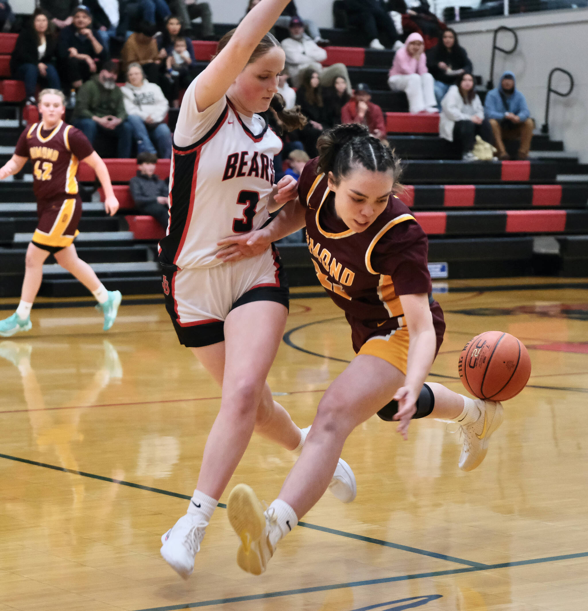 Juneau-Douglas High School: Yadaa.at Kalé junior Cambrey Lockhart (3) forces a turnover by Dimond senior Sienna Pederson during the Crimson Bears 53-43 loss to the Lynx on Saturday in the George Houston Gymnasium. (Klas Stolpe / Juneau Empire)