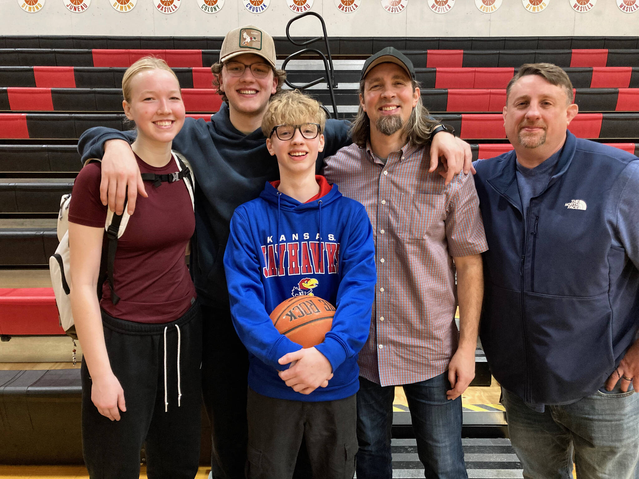 Evan, Maquire, Quince, Chris and Jer Hamey pose for a family photo on Saturday inside the George Houston Gymnasium. (Klas Stolpe / Juneau Empire)