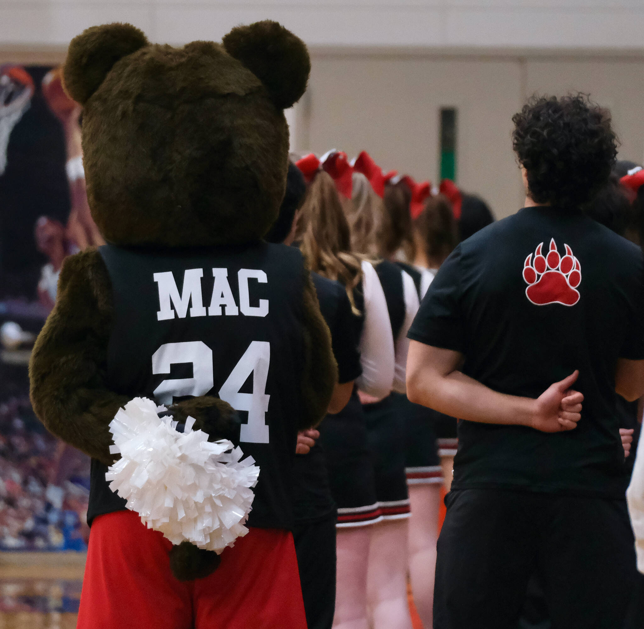 The Juneau-Douglas High School: Yadaa.at Kalé cheer team stands for the national anthem during Saturday’s Crimson Bears game against visiting Dimond Lynx. (Klas Stolpe / Juneau Empire)