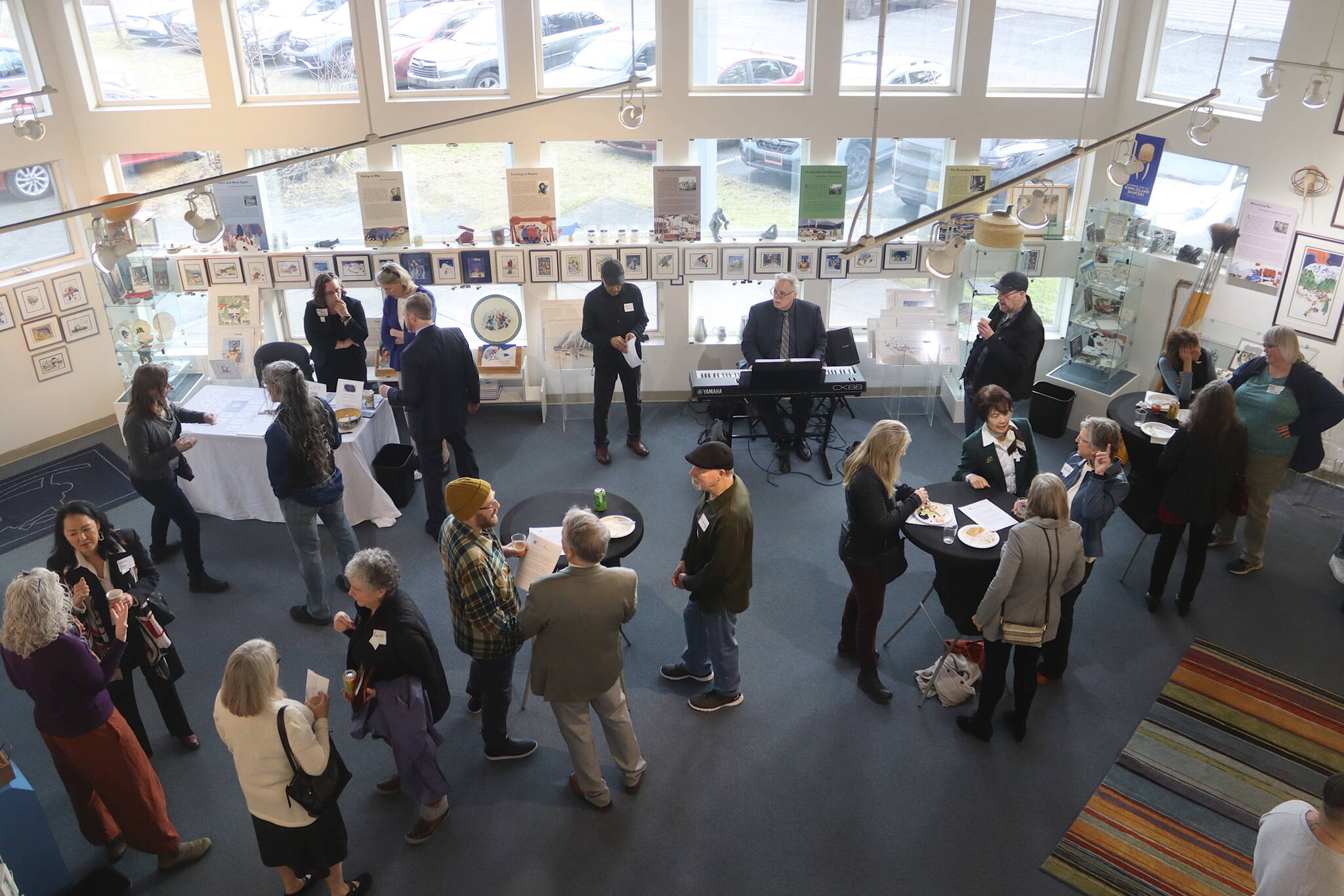 Hosts and guests mingle at a fundraising brunch on behalf of the Alaska Cultural Trust at the Rie Muñoz Gallery on Sunday. (Mark Sabbatini / Juneau Empire)