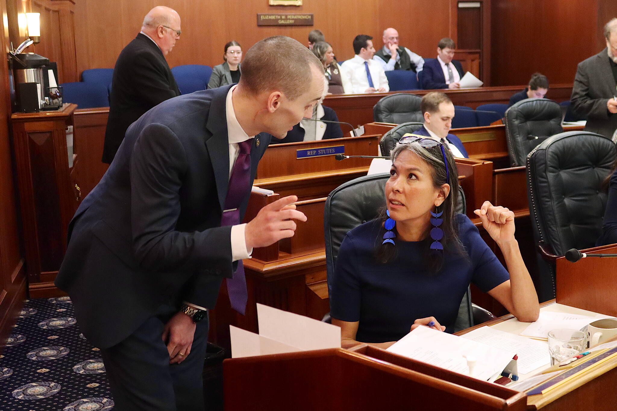 State Rep. Maxine Dibert (right), a Fairbanks Democrat, confers with Rep. Calvin Schrage (I-Anchorage) about a resolution opposing the change of Denali back to Mount McKinley during the House floor session at the Alaska State Capitol on Monday. (Mark Sabbatini / Juneau Empire)