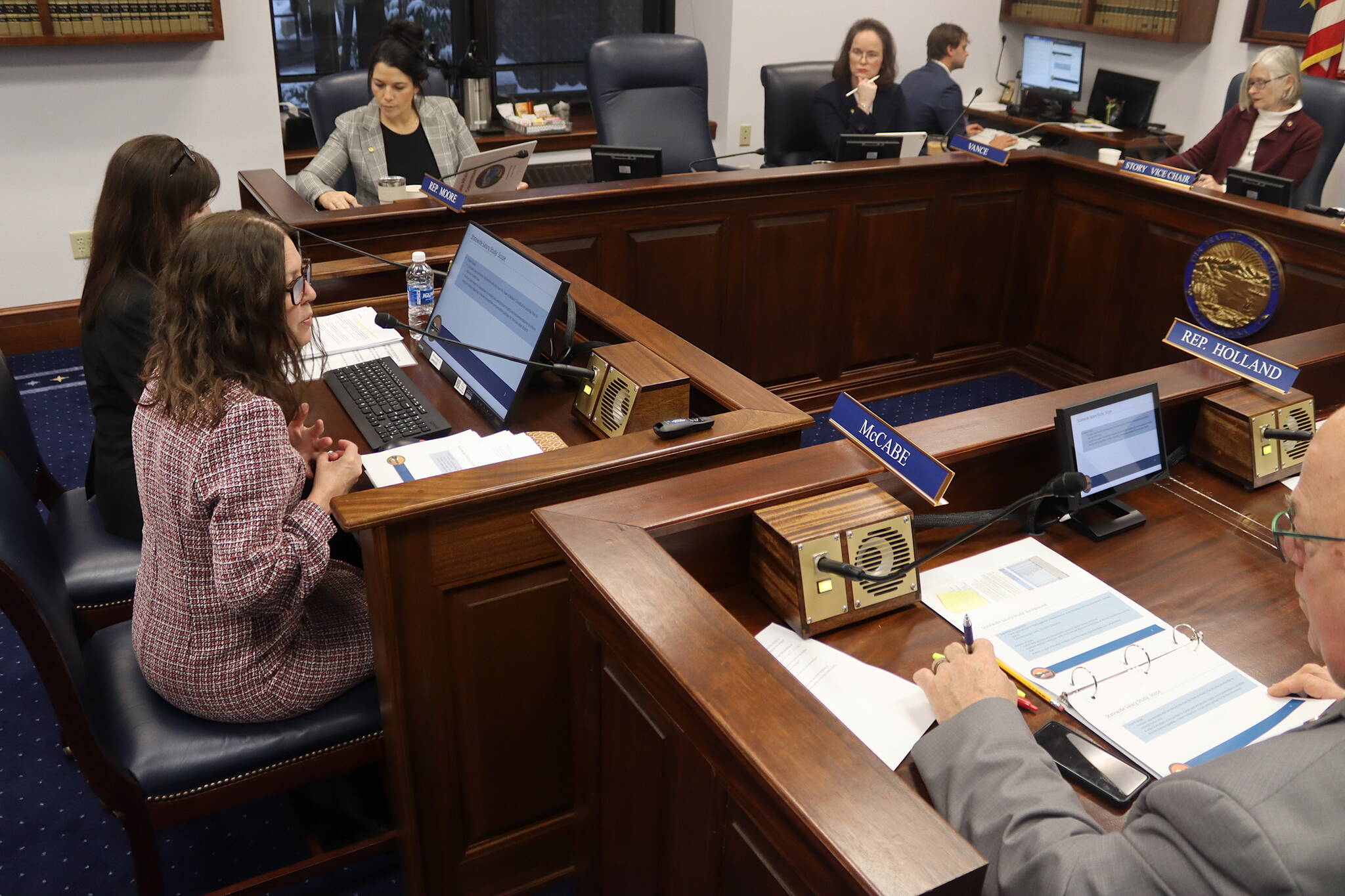 Kate Sheehan (left foreground), director of the Alaska Division of Personnel and Labor Relations, and Paula Vrana, commissioner of the Alaska Department of Administration, discuss an ongoing statewide salary study during a House State Affairs Committee meeting Thursday, Jan. 30, 2025, at the Alaska State Capitol. (Mark Sabbatini / Juneau Empire)