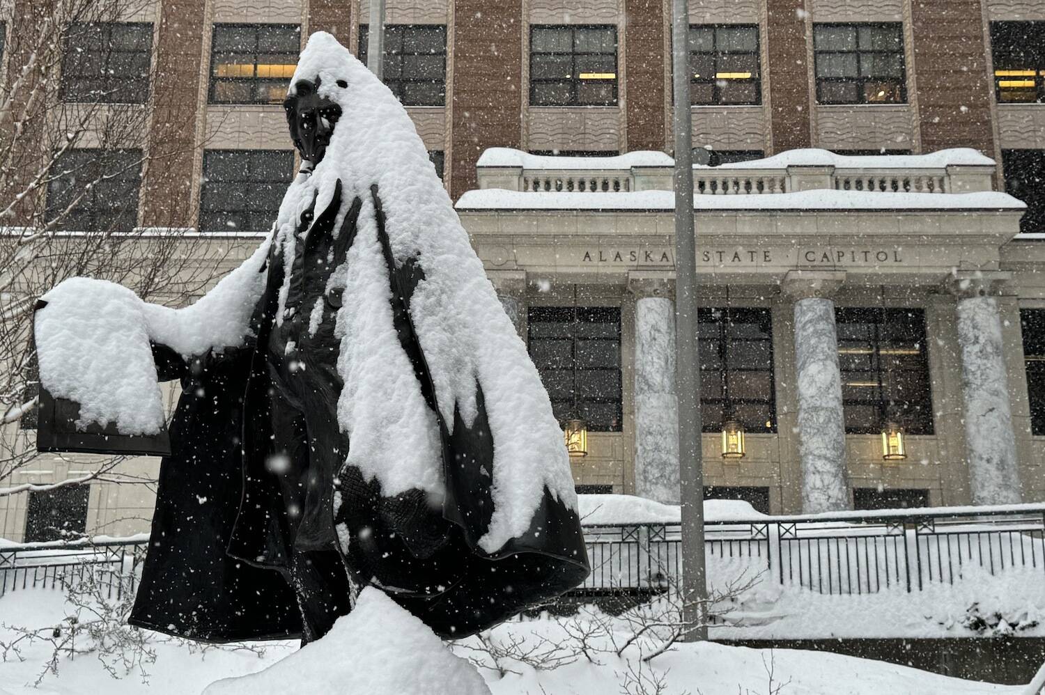 The statue of William Henry Seward in front of the Alaska State Capitol is seen covered in snow on Monday, Jan. 21, 2024. (James Brooks/Alaska Beacon)