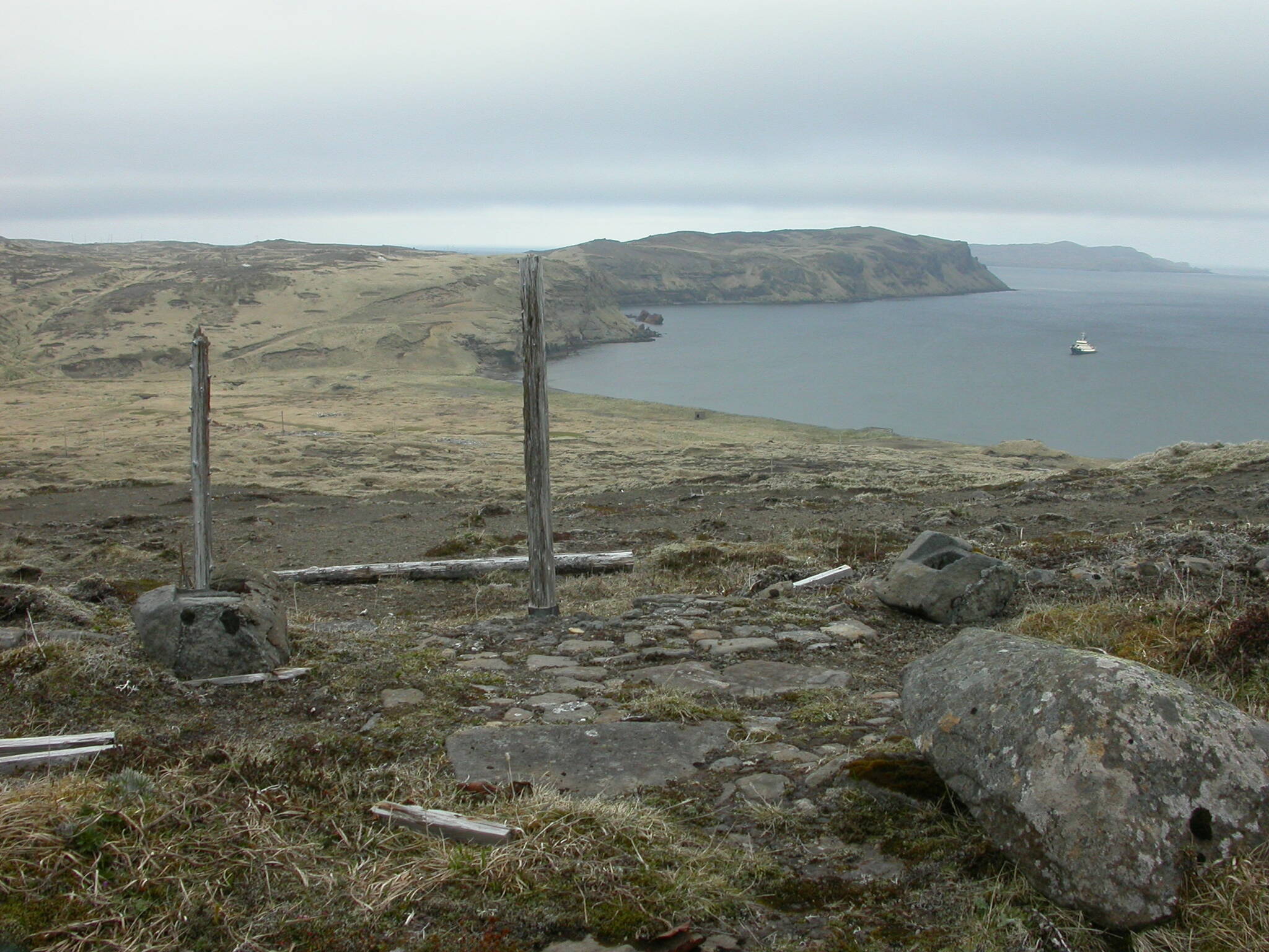 A Shinto shrine remains on Kiska Island after a brief Japanese occupation during World War II. The Alaska Maritime National Wildlife Refuge’s ship, the Tiglax, floats in the background. (Photo by Ned Rozell)