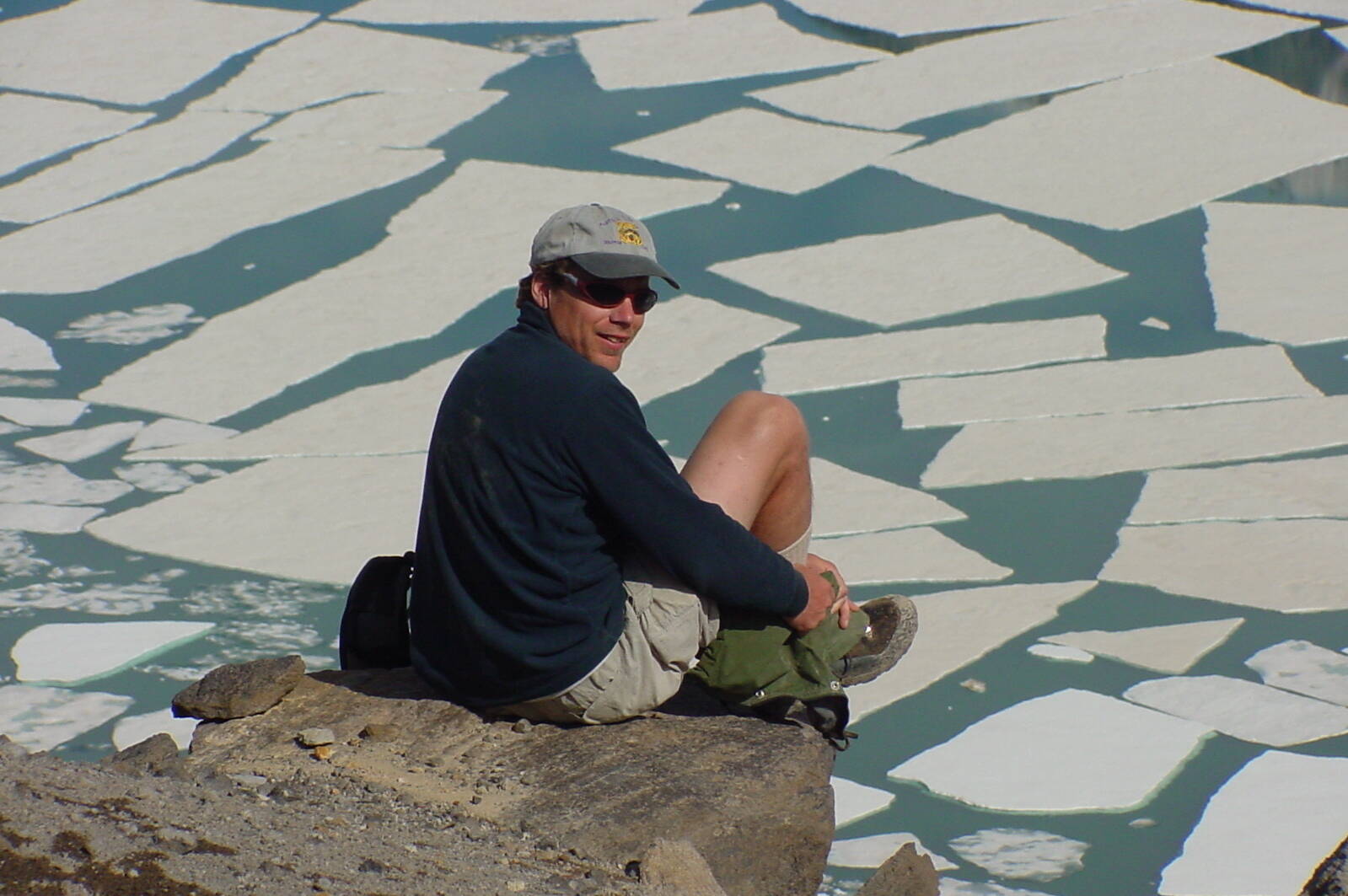 Ned Rozell sits at the edge of the volcanic crater on Mount Katmai during a trip to the Valley of 10,000 Smokes in 2001. (Photo by John Eichelberger)