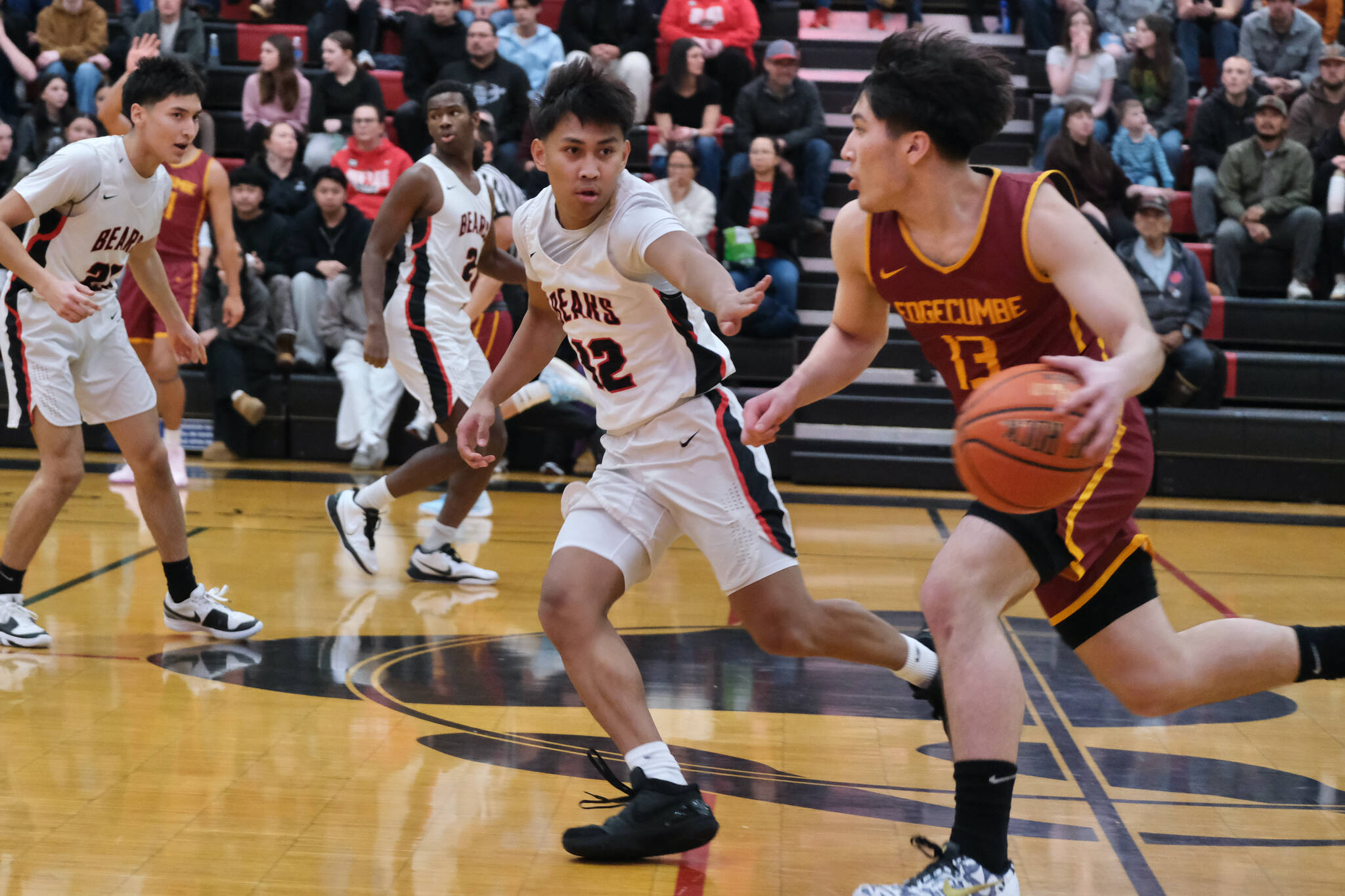 Juneau-Douglas High School: Yadaa.at Kalé junior Joren Gasga (12) defends Mt. Edgecumbe sophomore Kaden Herrmann (13) during the Crimson Bears 80-66 loss to the Braves on Friday in the George Houston Gymnasium. The two teams play again Saturday at 6 p.m. (Klas Stolpe / Juneau Empire)