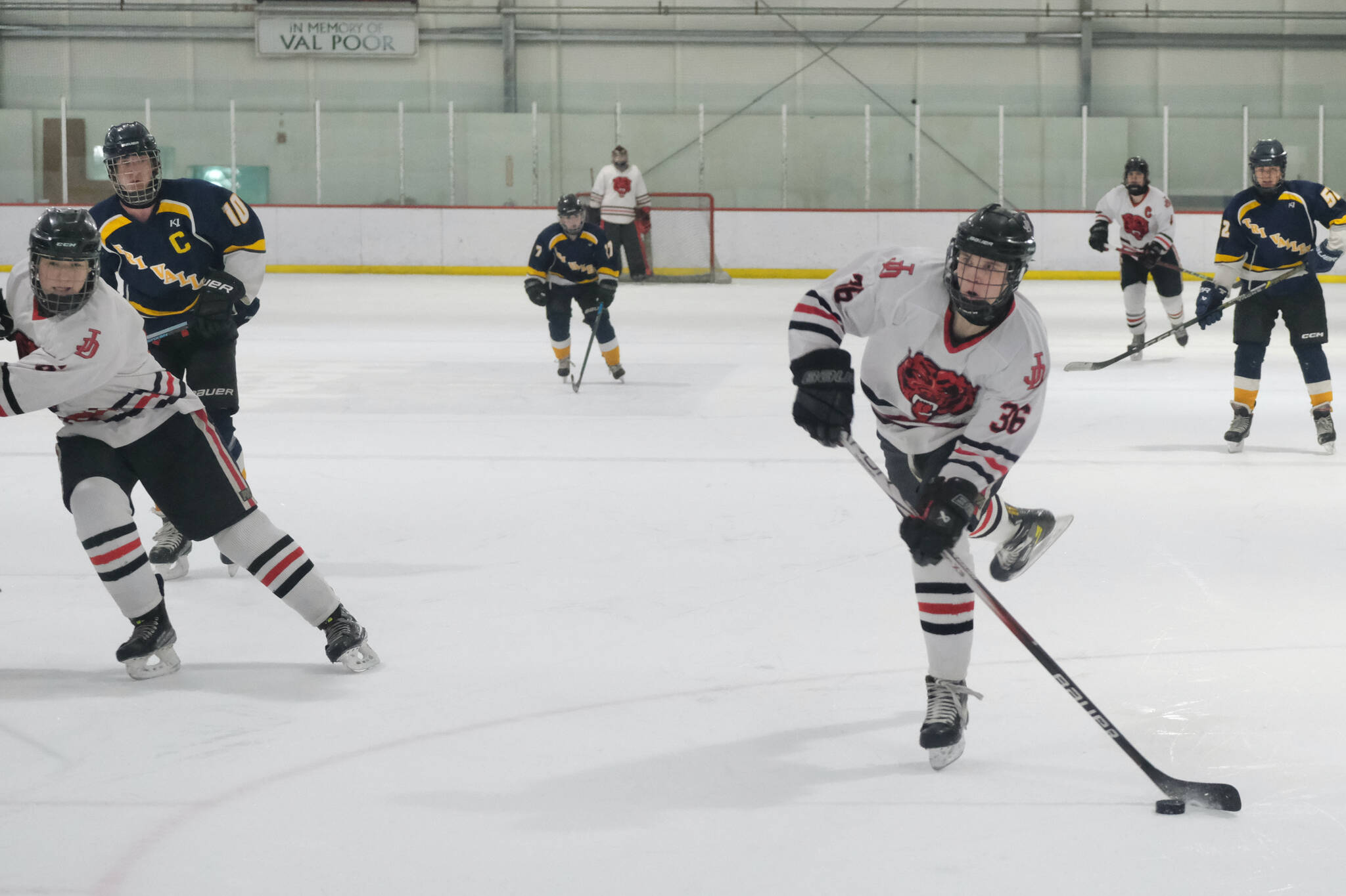 Crimson Bears junior Elliot Welch scores on a slap shot during Friday's 8-3 Juneau-Douglas High School: Yadaa.at Kalé win over the Warriors at Treadwell Ice Arena. (Klas Stolpe / Juneau Empire)