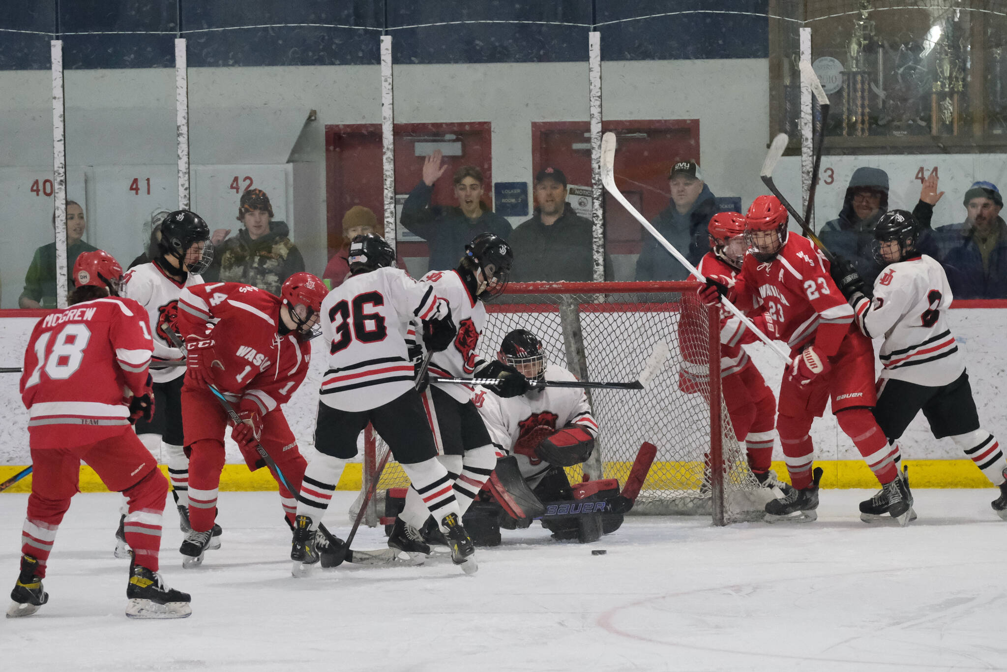 Juneau-Douglas High School: Yadaa.at Kalé senior goalie Caleb Friend keeps the puck out of the net during the Crimson Bears’ 3-1 win over the Warriors at Treadwell Ice Arena on Saturday. (Klas Stolpe / Juneau Empire)