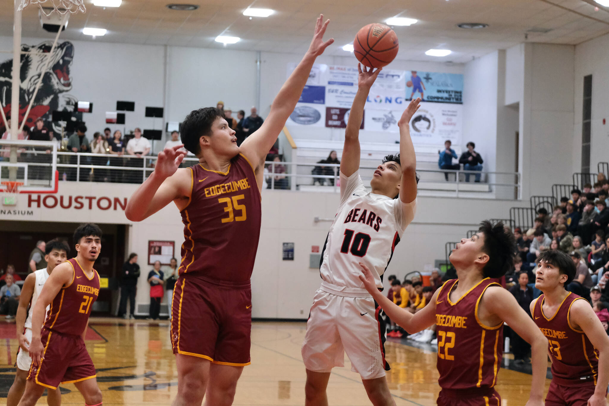 Juneau-Douglas High School: Yadaa.at Kalé senior Pedrin Saceda-Hurt (10) attempts a shot over Mt. Edgecumbe senior Donovan Stephen-Standifer (35) during the Crimson Bears’ 68-47 loss to the Braves on Saturday in the George Houston Gymnasium. (Klas Stolpe / Juneau Empire)