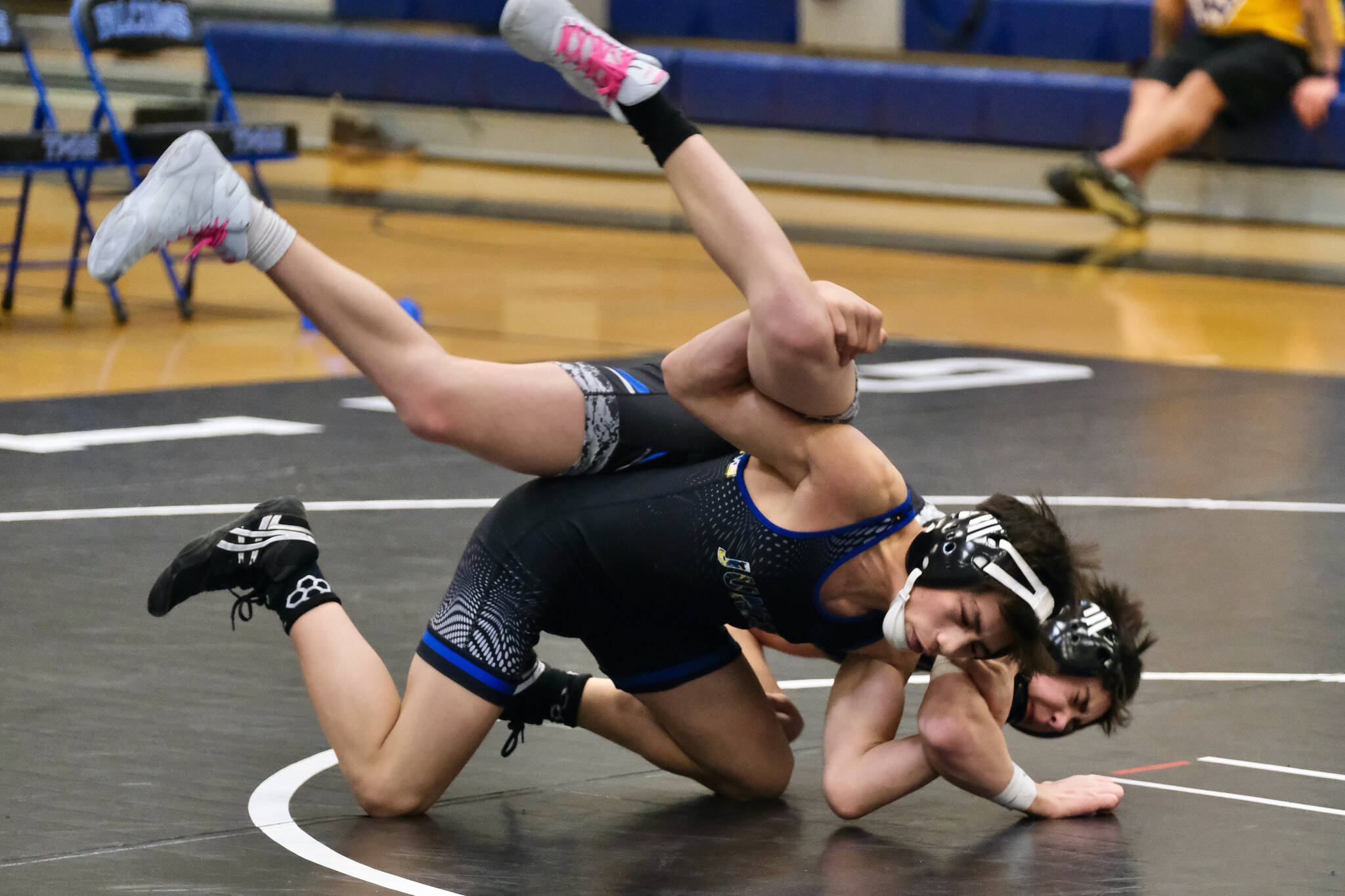 Thunder Mountain Middle School eighth grader Landon Hill of the Black Bear Legion uses a Fireman’s Carry to take down classmate Jack Pegues of team Orange Crush during the inaugural Thunder Mountain Mayhem Team Duels wrestling tournament Saturday at TMMS. (Klas Stolpe / Juneau Empire)