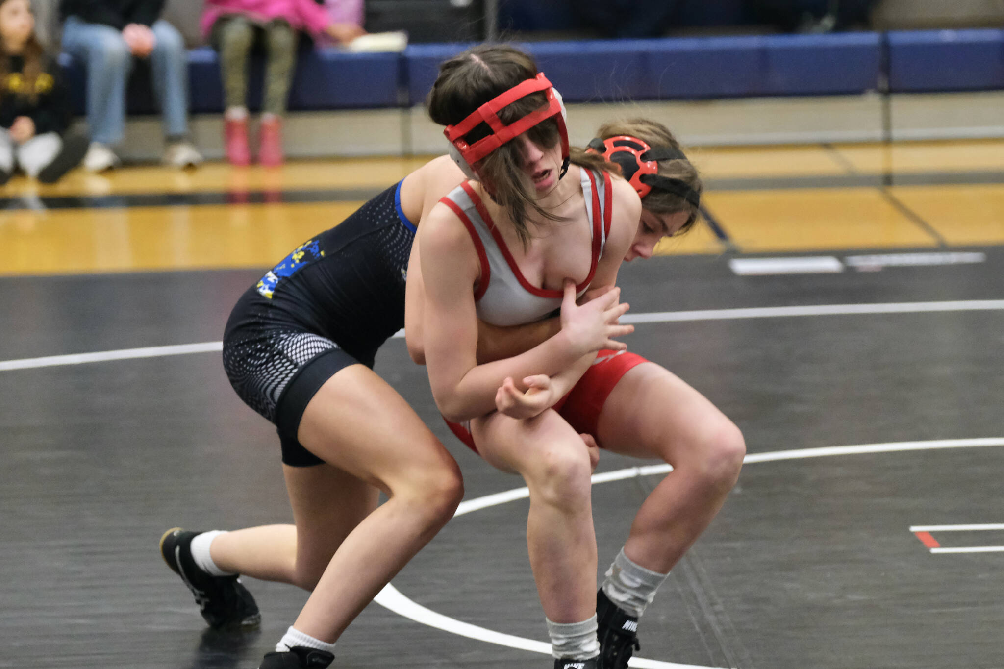 Thunder Mountain Middle School seventh grader Minali Reid of War Hawks White attempts to take down eighth grader Fiona McFarlin of Blue Barracuda Bombers during the inaugural Thunder Mountain Mayhem Team Duels wrestling tournament Saturday at TMMS. (Klas Stolpe / Juneau Empire)