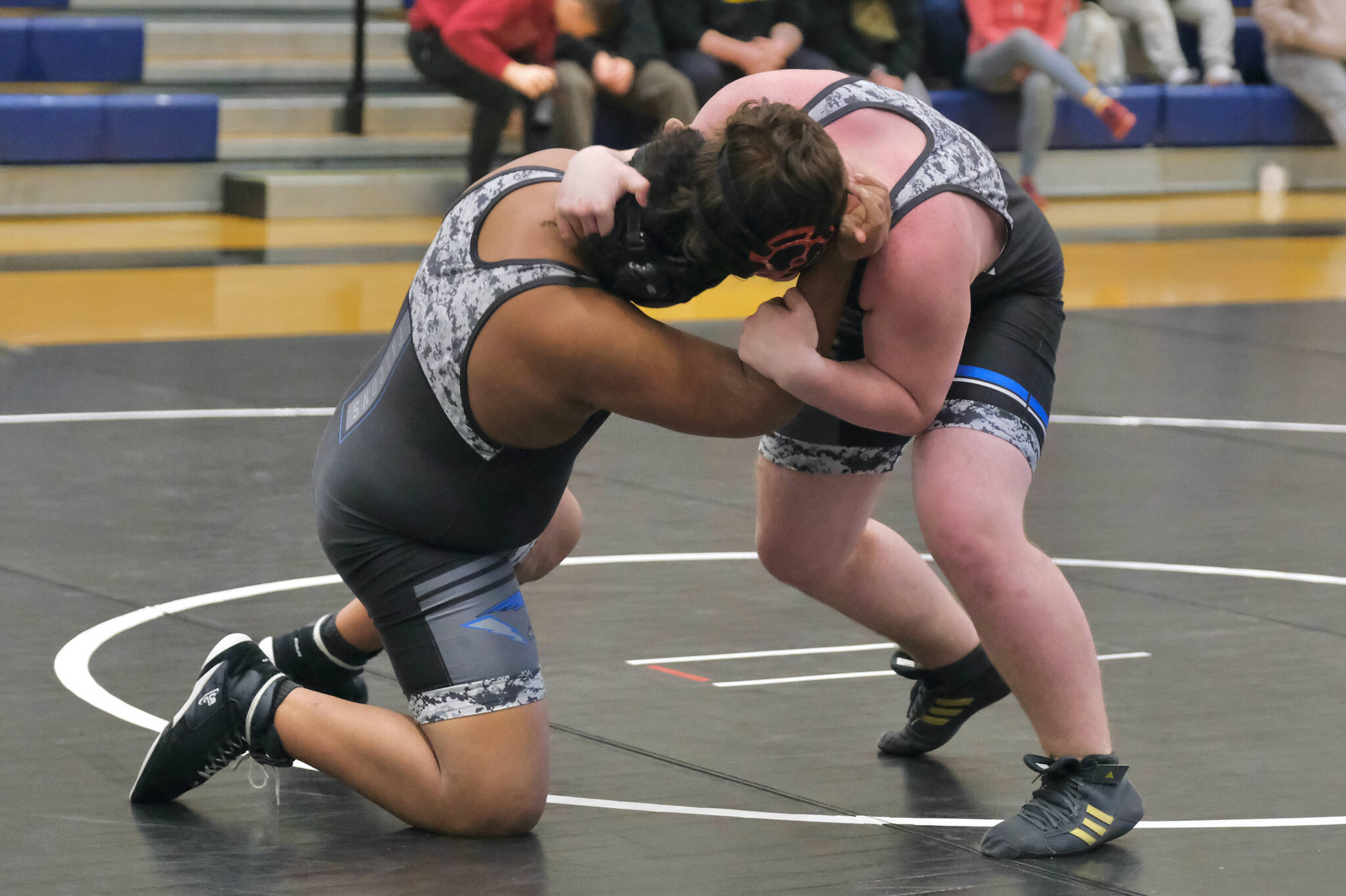 Thunder Mountain Middle School eighth graders Barron Marexo of Blue Barracuda Bombers and Braedon Lee Antrim of team War Hawks White go head-to-head during the inaugural Thunder Mountain Mayhem Team Duels wrestling tournament Saturday at TMMS. (Klas Stolpe / Juneau Empire)